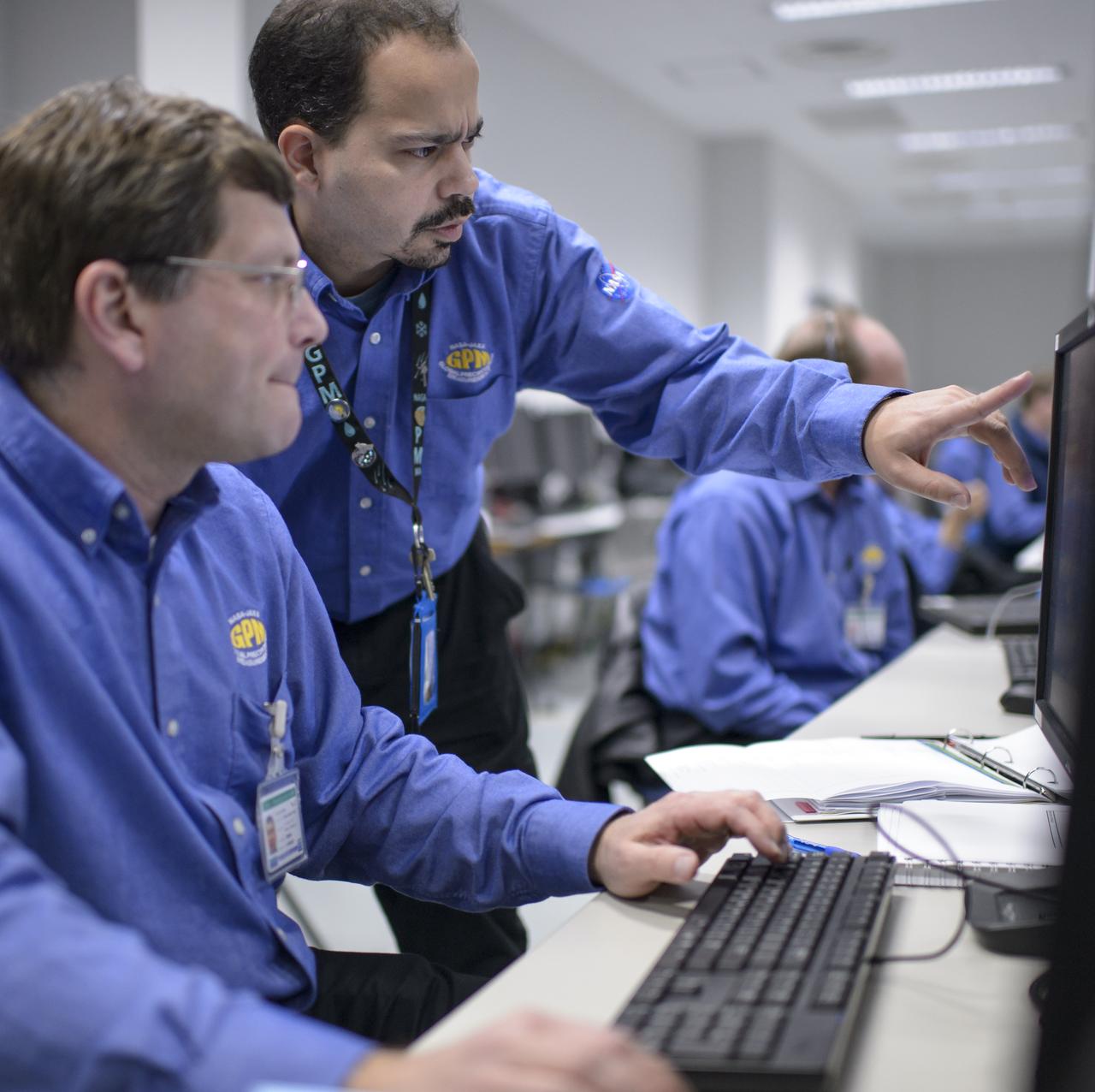 NASA GPM Systems team member Tim Grunner, left, and NASA GPM Test Conductor John Pope talk during an all-day launch simulation for the Global Precipitation Measurement (GPM) Core Observatory at the Spacecraft Test and Assembly Building 2 (STA2), Saturday, Feb. 22, 2014, Tanegashima Space Center (TNSC), Tanegashima Island, Japan. Japan Aerospace Exploration Agency (JAXA) plans to launch an H-IIA rocket carrying the GPM Core Observatory on Feb. 28, 2014. The NASA-JAXA GPM spacecraft will collect information that unifies data from an international network of existing and future satellites to map global rainfall and snowfall every three hours. Photo Credit: (NASA/Bill Ingalls)