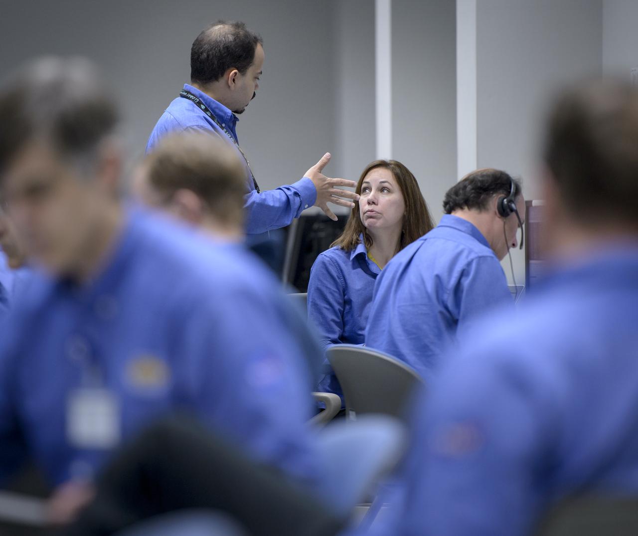 NASA GPM Test Conductors John Pope, and, Michelle Lacombe talk during the all-day launch simulation for the Global Precipitation Measurement (GPM) Core Observatory at the Spacecraft Test and Assembly Building 2 (STA2), Saturday, Feb. 22, 2014, Tanegashima Space Center (TNSC), Tanegashima Island, Japan. Japan Aerospace Exploration Agency (JAXA) plans to launch an H-IIA rocket carrying the GPM Core Observatory on Feb. 28, 2014. The NASA-JAXA GPM spacecraft will collect information that unifies data from an international network of existing and future satellites to map global rainfall and snowfall every three hours. Photo Credit: (NASA/Bill Ingalls)