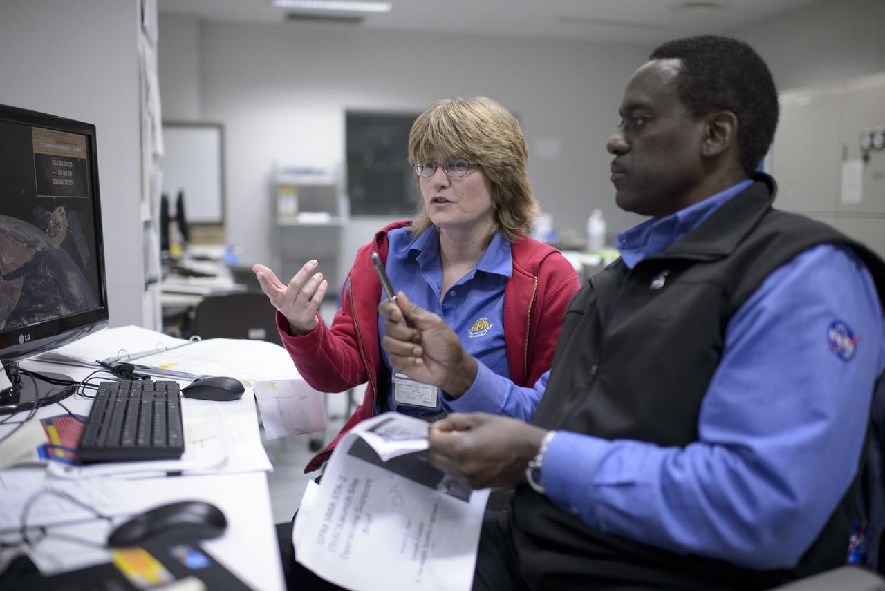 NASA GPM Safety Quality and Assurance, Shirley Dion, and, NASA GPM Quality and Assurance, Larry Morgan, monitor the all-day launch simulation for the Global Precipitation Measurement (GPM) Core Observatory at the Spacecraft Test and Assembly Building 2 (STA2), Saturday, Feb. 22, 2014, Tanegashima Space Center (TNSC), Tanegashima Island, Japan. Japan Aerospace Exploration Agency (JAXA) plans to launch an H-IIA rocket carrying the GPM Core Observatory on Feb. 28, 2014. The NASA-JAXA GPM spacecraft will collect information that unifies data from an international network of existing and future satellites to map global rainfall and snowfall every three hours. Photo Credit: (NASA/Bill Ingalls)