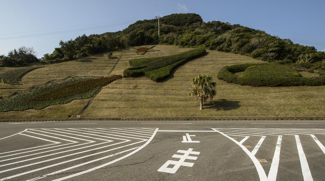 Shrubs and flowers in the shape of a space shuttle, star and planet are seen just outside the visitor's center of the Tanegashima Space Center (TNSC), Sunday, Feb. 23, 2014, Tanegashima Island, Japan. A Japanese H-IIA rocket carrying the NASA-Japan Aerospace Exploration Agency (JAXA), Global Precipitation Measurement (GPM) Core Observatory is planned for launch from the space center on Feb. 28, 2014. Once launched, the GPM spacecraft will collect information that unifies data from an international network of existing and future satellites to map global rainfall and snowfall every three hours.  Photo Credit: (NASA/Bill Ingalls)
