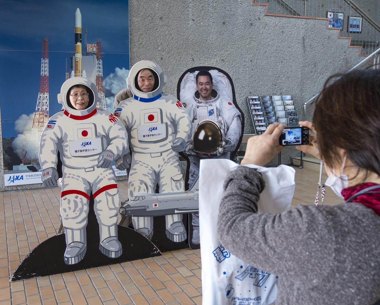 Tourist photograph themselves in astronaut space suites next to a cardboard cutout of Japan Aerospace Exploration Agency (JAXA) Astronaut Akihiko Hoshide at the visitor's center of the Tanegashima Space Center (TNSC), Sunday, Feb. 23, 2014, Tanegashima Island, Japan. A Japanese H-IIA rocket carrying the NASA-Japan Aerospace Exploration Agency (JAXA), Global Precipitation Measurement (GPM) Core Observatory is planned for launch from the space center on Feb. 28, 2014. Once launched, the GPM spacecraft will collect information that unifies data from an international network of existing and future satellites to map global rainfall and snowfall every three hours.  Photo Credit: (NASA/Bill Ingalls)