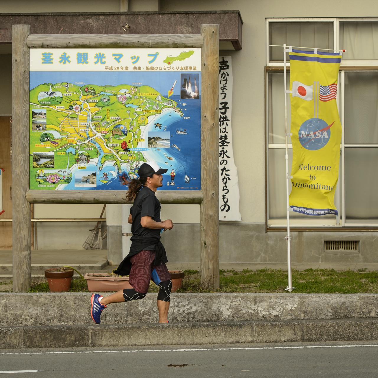 A jogger runs past a sign welcoming NASA and other visitors to Minamitane Town on Sunday, Feb. 23, 2014, Tanegashima Island, Japan. A Japanese H-IIA rocket carrying the NASA-Japan Aerospace Exploration Agency (JAXA), Global Precipitation Measurement (GPM) Core Observatory is planned for launch from the space center on Feb. 28, 2014. Once launched, the GPM spacecraft will collect information that unifies data from an international network of existing and future satellites to map global rainfall and snowfall every three hours.  Photo Credit: (NASA/Bill Ingalls)