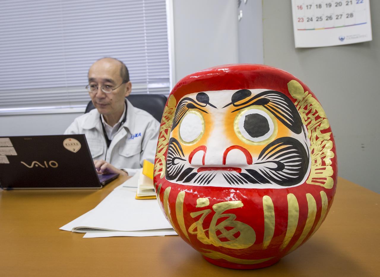 A daruma doll is seen on the desk of Masahiro Kojima, GPM Dual-frequency Precipitation Radar project manager, Japan Aerospace Exploration Agency (JAXA), at the Tanegashima Space Cener's Range Control Center (RCC), Wednesday, Feb. 26, 2014, Tanegashima, Japan. One eye of the daruma doll is colored in when a goal is set and the second eye is colored in at the completion of the goal. JAXA plans to launch an H-IIA rocket carrying the NASA-JAXA, Global Precipitation Measurement (GPM) Core Observatory from the space center on Feb. 28, 2014. Once launched, the GPM spacecraft will collect information that unifies data from an international network of existing and future satellites to map global rainfall and snowfall every three hours. Photo Credit: (NASA/Bill Ingalls)