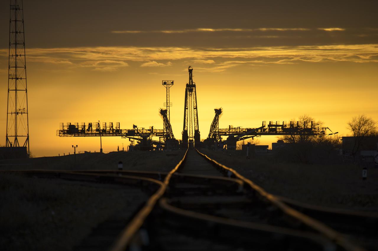 The sun rises behind the Soyuz launch pad shortly before the Soyuz TMA-12M spacecraft is rolled out by train to the launch pad at the Baikonur Cosmodrome, Kazakhstan, Sunday, March, 23, 2014.  Launch of the Soyuz rocket is scheduled for March 26 and will send Expedition 39 Soyuz Commander Alexander Skvortsov of the Russian Federal Space Agency, Roscosmos, Flight Engineer Steven Swanson of NASA, and Flight Engineer Oleg Artemyev of Roscosmos on a six-month mission aboard the International Space Station. Photo Credit (NASA/Bill Ingalls)