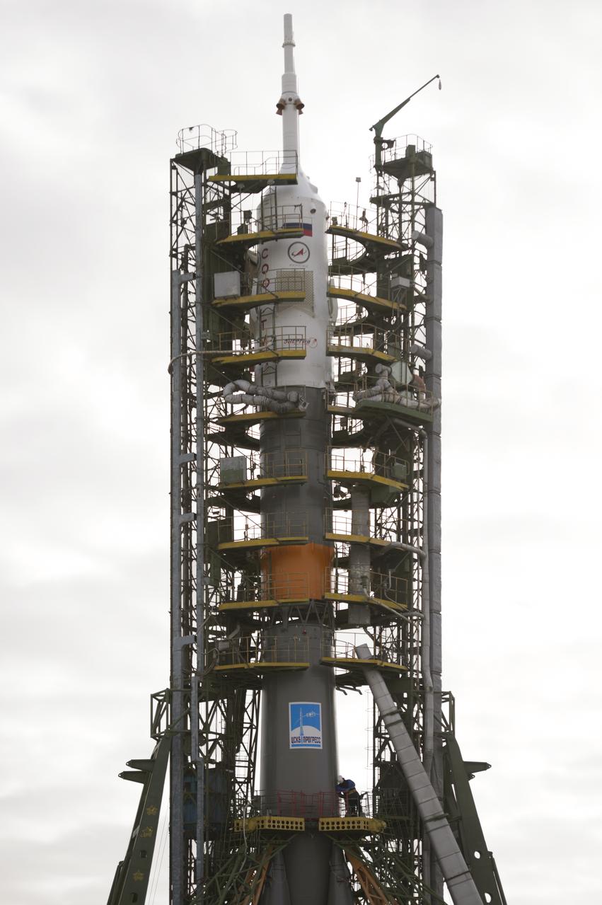 The gantry arms close around the Soyuz TMA-12M spacecraft to secure the rocket at the launch pad on Sunday, March 23, 2014, at the Baikonur Cosmodrome in Kazakhstan.  Launch of the Soyuz rocket is scheduled for March 26 and will send Expedition 39 Soyuz Commander Alexander Skvortsov of the Russian Federal Space Agency, Roscosmos, Flight Engineer Steven Swanson of NASA, and Flight Engineer Oleg Artemyev of Roscosmos on a six-month mission aboard the International Space Station.  Photo Credit: (NASA/Joel Kowsky)