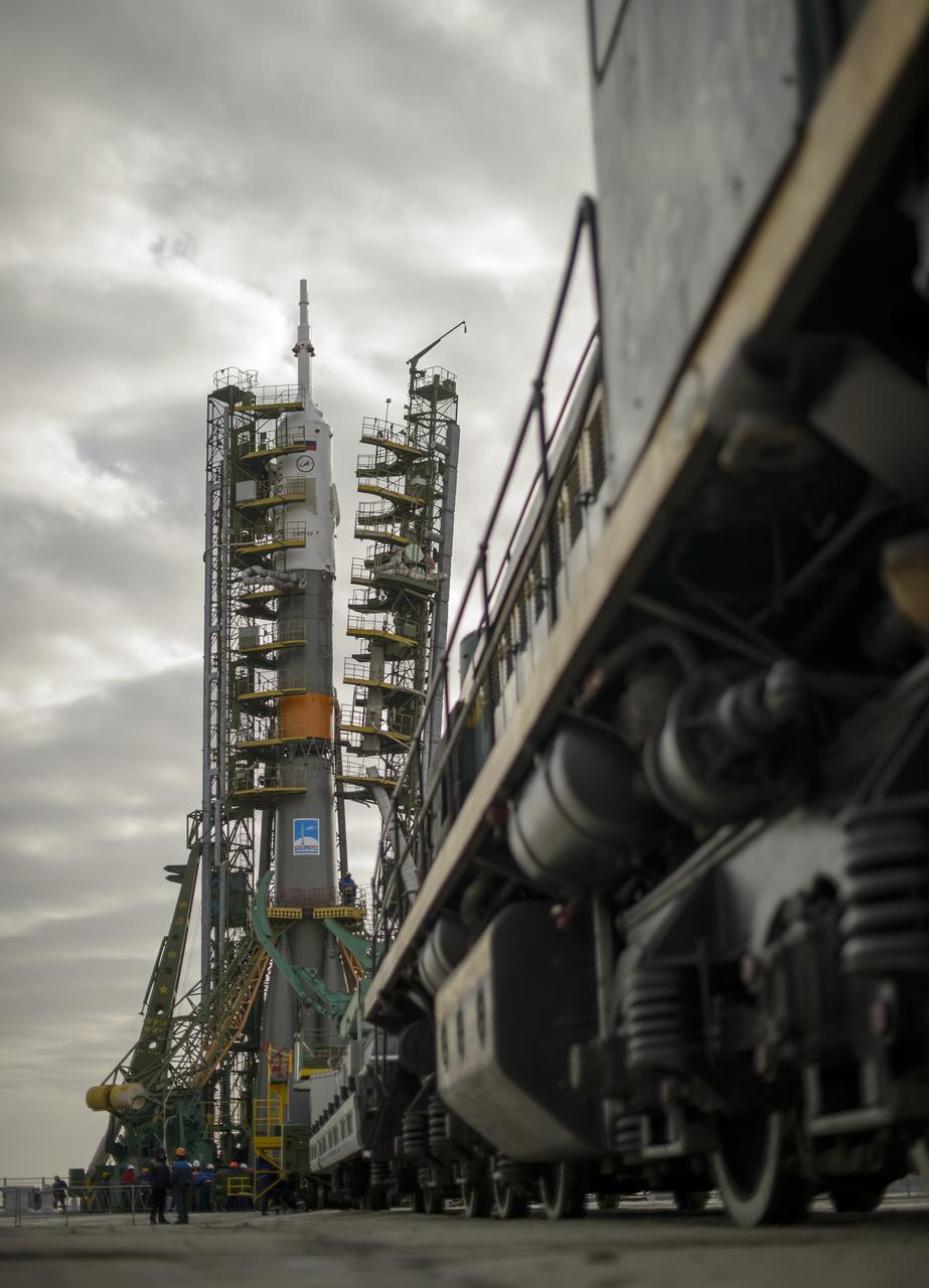 The gantry arms close around the Soyuz TMA-12M spacecraft to secure the rocket at the launch pad on Sunday, March 23, 2014, at the Baikonur Cosmodrome in Kazakhstan.  Launch of the Soyuz rocket is scheduled for March 26 and will send Expedition 39 Soyuz Commander Alexander Skvortsov of the Russian Federal Space Agency, Roscosmos, Flight Engineer Steven Swanson of NASA, and Flight Engineer Oleg Artemyev of Roscosmos on a six-month mission aboard the International Space Station.  Photo Credit: (NASA/Bill Ingalls)