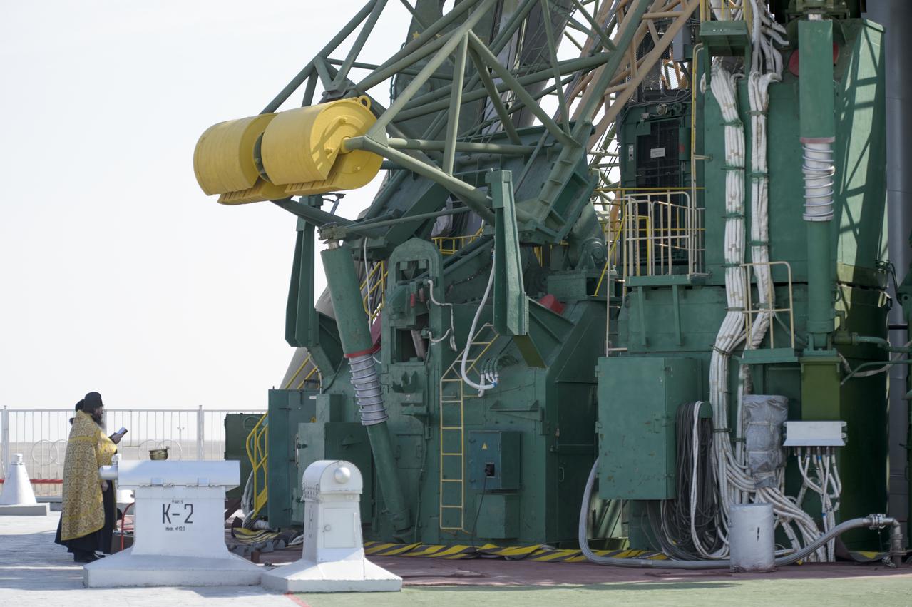 An Orthodox priest blesses the Soyuz rocket at the Baikonur Cosmodrome launch pad on Monday, March 24, 2014 in Kazakhstan.  Launch of the Soyuz rocket is scheduled for March 26 and will send  Expedition 39 Soyuz Commander Alexander Skvortsov of the Russian Federal Space Agency, Flight Engineer Steve Swanson of NASA, and Flight Engineer Oleg Artemyev of Roscosmos on a six-month mission aboard the International Space Station.Photo Credit: (NASA/Joel Kowsky)