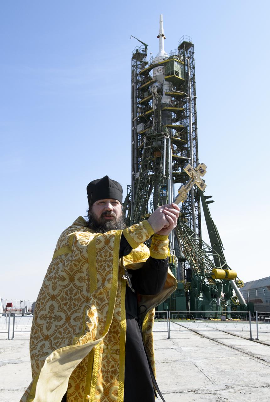 An Orthodox priest blesses members of the media on the Soyouz launch pad at the Baikonur Cosmodrome launch pad on Monday, March 24, 2014 in Kazakhstan.  Launch of the Soyuz rocket is scheduled for March 26 and will send  Expedition 39 Soyuz Commander Alexander Skvortsov of the Russian Federal Space Agency, Flight Engineer Steve Swanson of NASA, and Flight Engineer Oleg Artemyev of Roscosmos on a six-month mission aboard the International Space Station.Photo Credit: (NASA/Joel Kowsky)