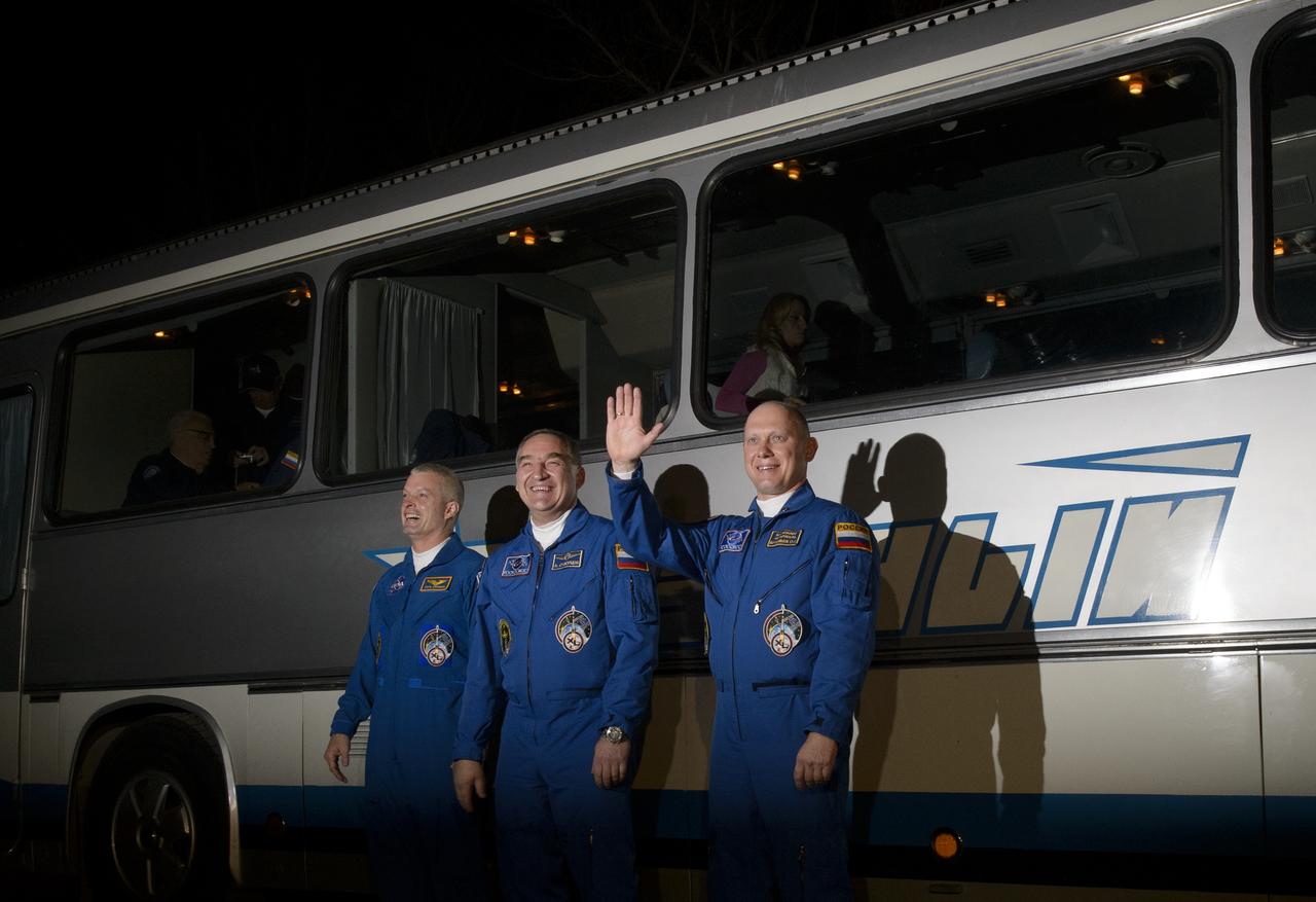 Expedition 39 Flight Engineer Steve Swanson of NASA, left, Soyuz Commander Alexander Skvortsov the Russian Federal Space Agency, Roscosmos, center, and Flight Engineer Oleg Artemyev of Roscosmos, right, are seen as they depart the Cosmonaut Hotel, Tuesday, March 25, 2014, in Baikonur, Kazakhstan. The trio is set to launch on a six month mission to the International Space Station onboard the Soyuz TMA-12M spacecraft at 3:17 a.m. Kazakhstan time on Wednesday, March 26.  Photo Credit: (NASA/Joel Kowsky)