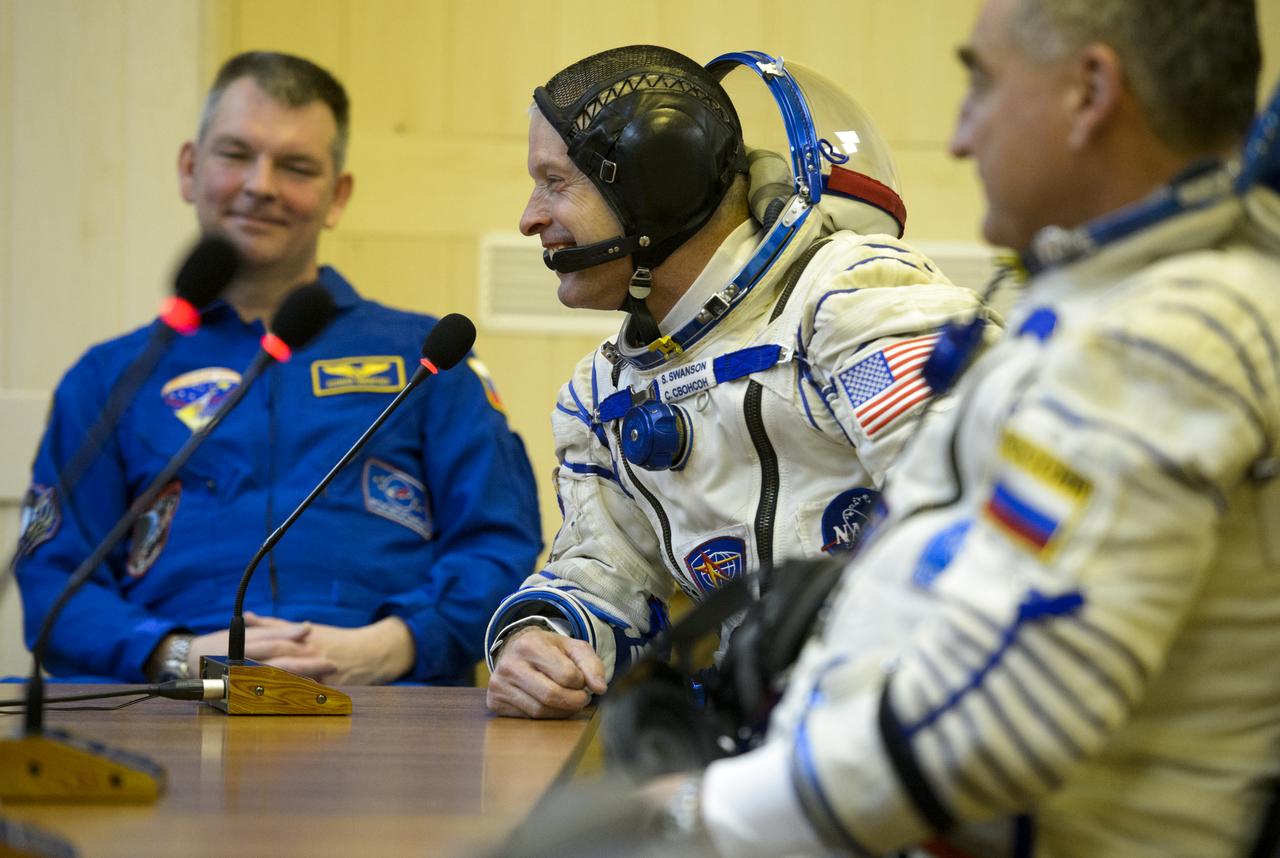 Expedition 39 Flight Engineer Steve Swanson of NASA, center, speaks with his family during Russian Sokol suit pressure checks in preparation for launch onboard the Soyuz TMA-12M spacecraft on Tuesday, March 25, 2014 at the Baikonur Cosmodrome in Kazakhstan. The Soyuz spacecraft with Swanson, Expedition 39 Soyuz Commander Alexander Skvortsov of the Russian Federal Space Agency, Roscosmos, and Flight Engineer Oleg Artemyev of Roscosmos is scheduled to launch at 3:17 a.m. Kazakhstan time on Wednesday, March 26. (NASA/Joel Kowsky)