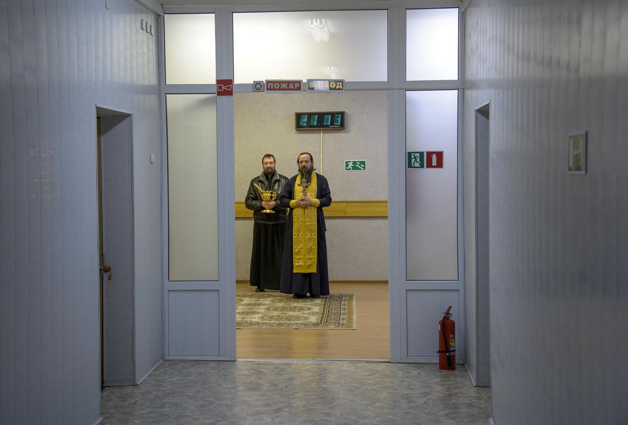 A Russian Orthodox priest stands ready to preform the traditional blessing of the crew at the Cosmonaut Hotel prior to the launch of Soyuz TMA-12M to the International Space Station, Tuesday, March 25, 2014, in Baikonur, Kazakhstan. Expedition 39 Soyuz Commander Alexander Skvortsov of the Russian Federal Space Agency, Roscosmos, Flight Engineer Steve Swanson of NASA, and Flight Engineer Oleg Artemyev of Roscosmos will spend six months living and working aboard the ISS. Photo Credit: (NASA/Bill Ingalls)