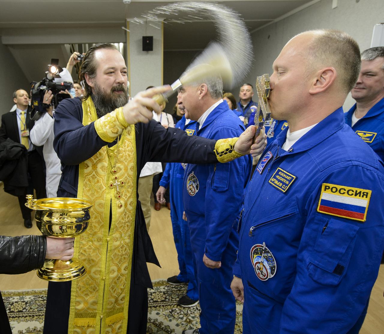 Flight Engineer Oleg Artemyev of the Russian Federal Space Agency, Roscosmos, right, receives the traditional blessing from a Russian Orthodox priest at the Cosmonaut Hotel prior to his launch on the Soyuz rocket to the International Space Station, Tuesday, March 25, 2014, in Baikonur, Kazakhstan. Artemyev, Soyuz Commander Alexander Skvortsov of the Russian Federal Space Agency, Roscosmos, and Flight Engineer Steve Swanson of NASA will spend six months living and working aboard the ISS. Photo Credit: (NASA/Bill Ingalls)
