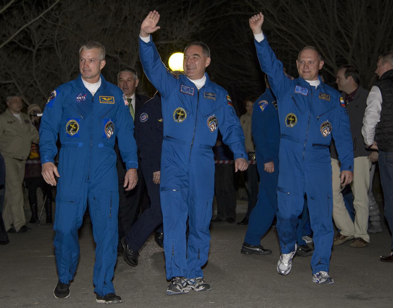 Expedition 39 Flight Engineer Steve Swanson of NASA, left, Soyuz Commander Alexander Skvortsov of the Russian Federal Space Agency, Roscosmos, center, and, Flight Engineer Oleg Artemyev of Roscosmos, right, are seen as they depart the Cosmonaut Hotel, Tuesday, March 25, 2014, in Baikonur, Kazakhstan. The trio is set to launch on a six month mission to the International Space Station onboard the Soyuz TMA-12M spacecraft at 3:17 a.m. Kazakhstan time on Wednesday, March 26. Photo Credit: (NASA/Bill Ingalls)