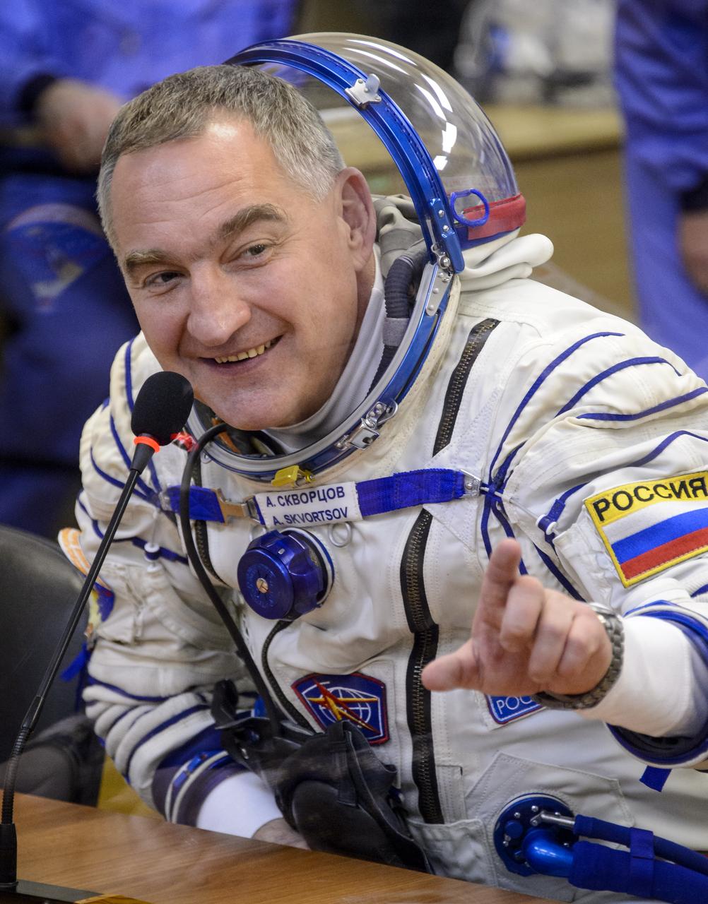 Expedition 39 Soyuz Commander Alexander Skvortsov of the Russian Federal Space Agency, Roscosmos, speaks with his family during Russian Sokol suit pressure checks in preparation for launch onboard the Soyuz TMA-12M spacecraft on Tuesday, March 25, 2014 at the Baikonur Cosmodrome in Kazakhstan. The Soyuz spacecraft with Skvortsov, Expedition 39 Flight Engineer Oleg Artemyev of Roscosmos and Flight Engineer Steve Swanson of NASA is scheduled to launch at 3:17 a.m. Kazakhstan time on Wednesday, March 26. (NASA/Bill Ingalls)