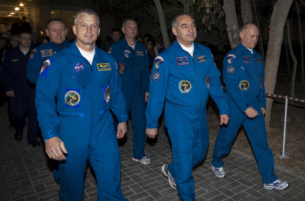 Expedition 39 Flight Engineer Steve Swanson of NASA, left, Soyuz Commander Alexander Skvortsov of the Russian Federal Space Agency, Roscosmos, center, and, Flight Engineer Oleg Artemyev of Roscosmos, right, are seen as they depart the Cosmonaut Hotel, Tuesday, March 25, 2014, in Baikonur, Kazakhstan. The trio launched on a six month mission to the International Space Station onboard the Soyuz TMA-12M spacecraft at 3:17 a.m. Kazakhstan time on Wednesday, March 26. Photo Credit: (NASA/Victor Zelentsov)