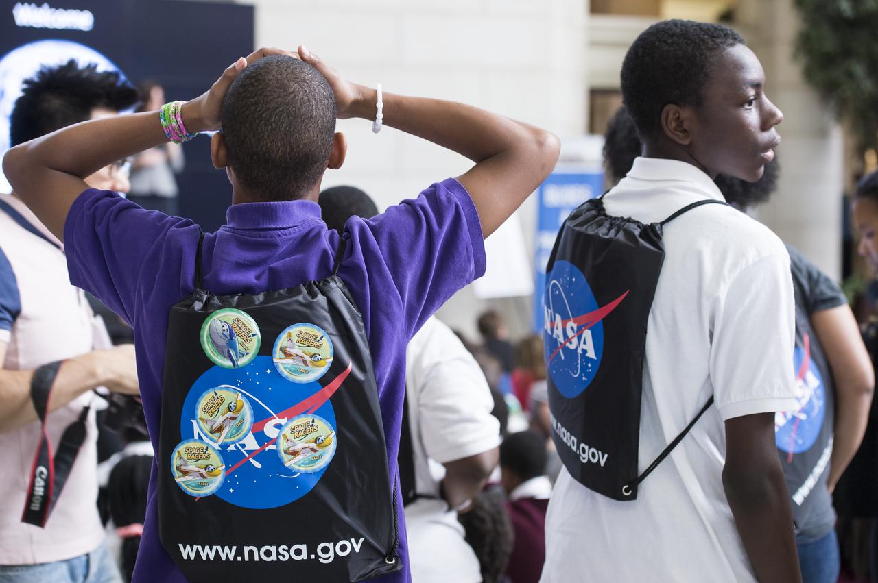 Students listen intently to a speaker while at NASA's Earth Day event. The event took place at Union Station in Washington, DC on April 22, 2014. Photo Credit: (NASA/Aubrey Gemignani)