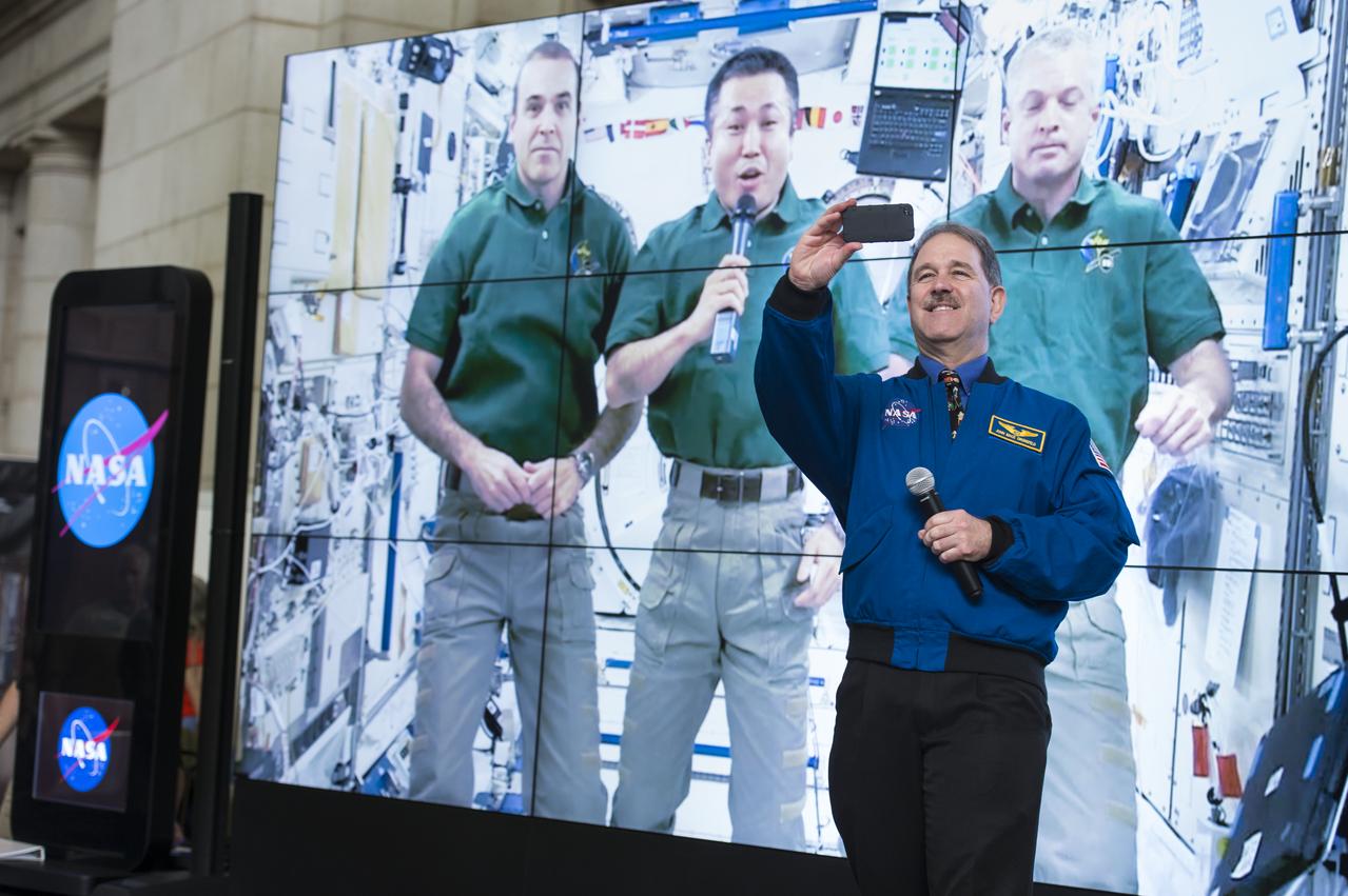 NASA Astronaut John Mace Grunsfeld takes a quick selfie with astronauts at the International Space Station at the NASA sponsored Earth Day event April 22, 2014 at Union Station in Washington, DC. NASA announced the "Global Selfie" event as part of its "Earth Right Now" campaign, celebrating the launch of five Earth-observing missions in 2014. All selfies posted to social media with the hashtag "GlobalSelfie" will be included in a mosaic image of Earth. Photo Credit: (NASA/Aubrey Gemignani)