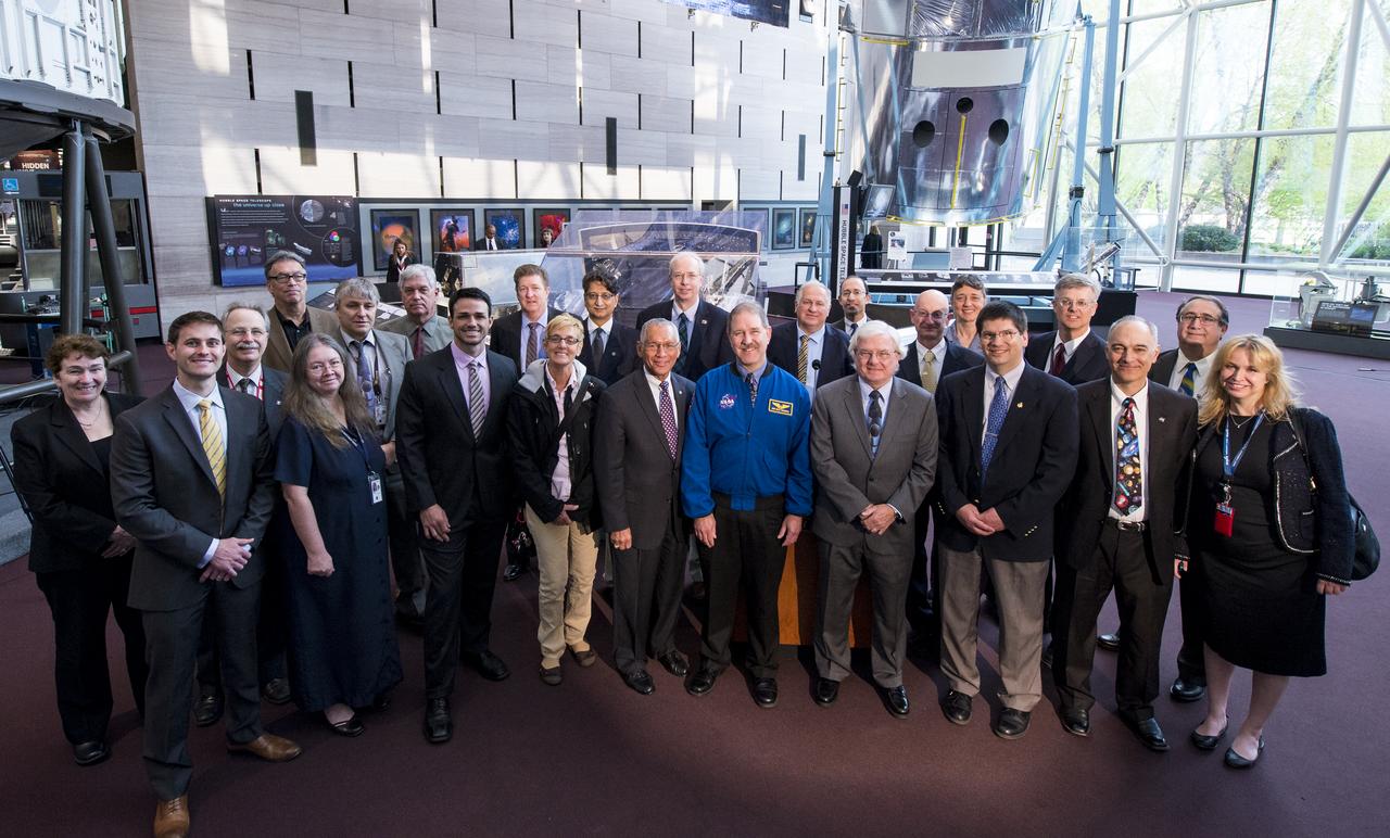 Individuals in attendance who had a hand in the development or servicing of the Hubble Space Telescope pose for a group photo at an event unveiling a new exhibit featuring Hubble's Corrective Optics Space Telescope Axial Replacement (COSTAR) and the WFPC2 on Wednesday, April 23, 2014 at the Smithsonian National Air and Space Museum in Washington, DC. COSTAR and WFPC2 were  installed in Hubble during the first space shuttle servicing mission in 1993 and returned to Earth on the fifth and final servicing mission in 2009.  Photo Credit: (NASA/Joel Kowsky)