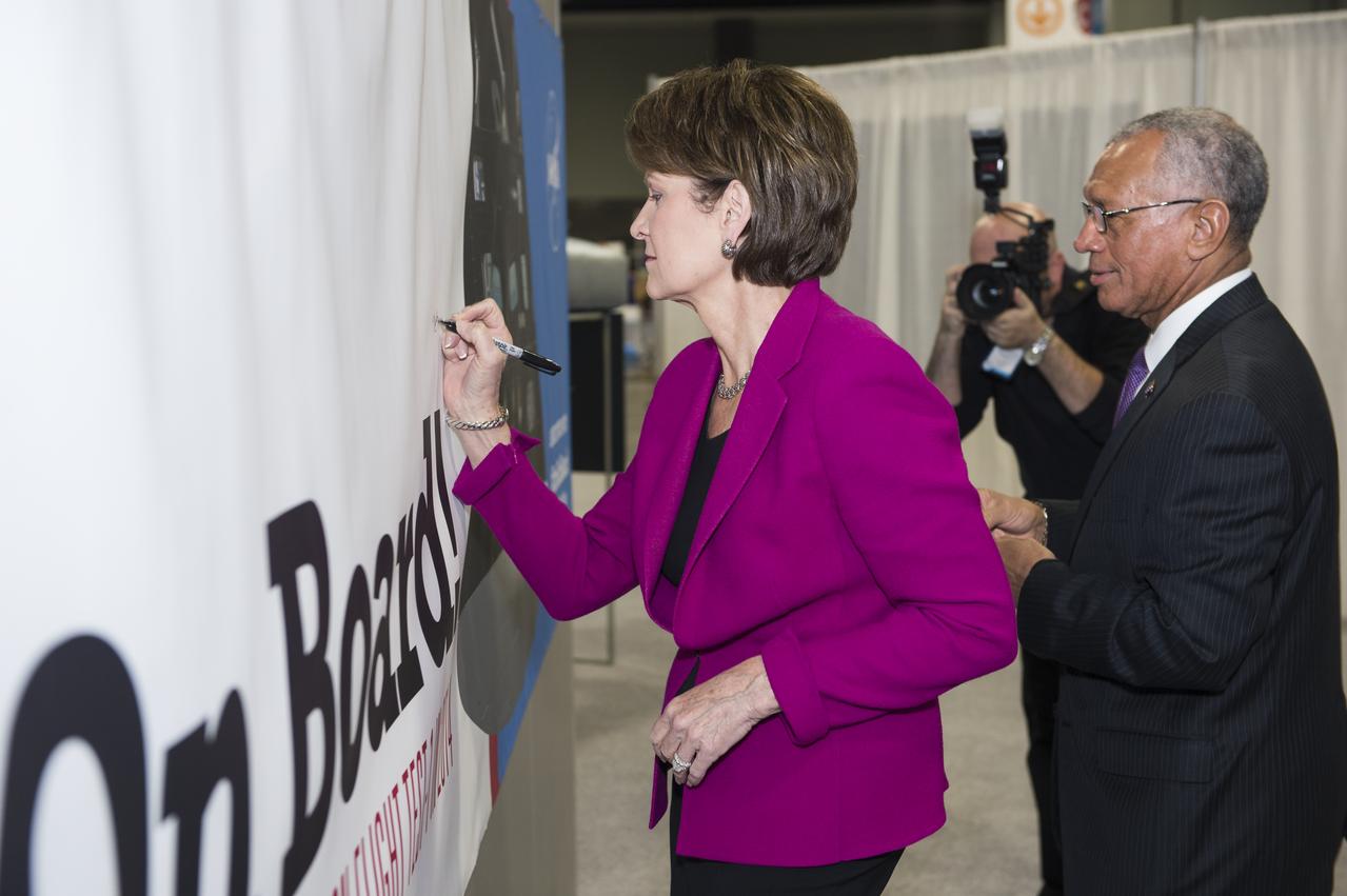 NASA Administrator Charles Bolden and Lockheed Martin CEO Marillyn Hewson sign the poster at the Orion exhibit at the USA Science and Engineering Festival on April 25, 2014. The USA Science and Engineering Festival takes place April 26-27, 2014 at the Washington Convention Center in Washington, DC. Photo Credit: (NASA/Aubrey Gemignani)