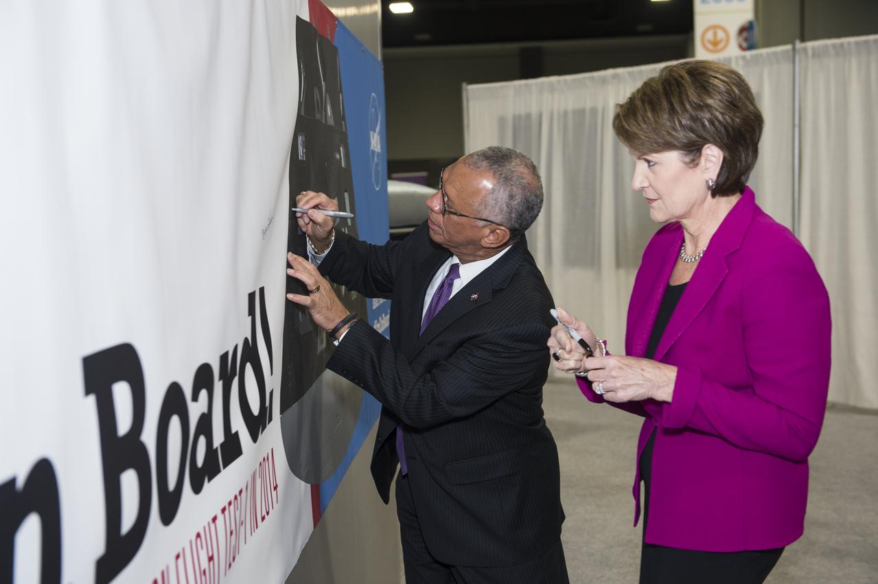 NASA Administrator Charles Bolden and Lockheed Martin CEO Marillyn Hewson sign the poster at the Orion exhibit at the USA Science and Engineering Festival on April 25, 2014. The USA Science and Engineering Festival takes place April 26-27, 2014 at the Washington Convention Center in Washington, DC. Photo Credit: (NASA/Aubrey Gemignani)