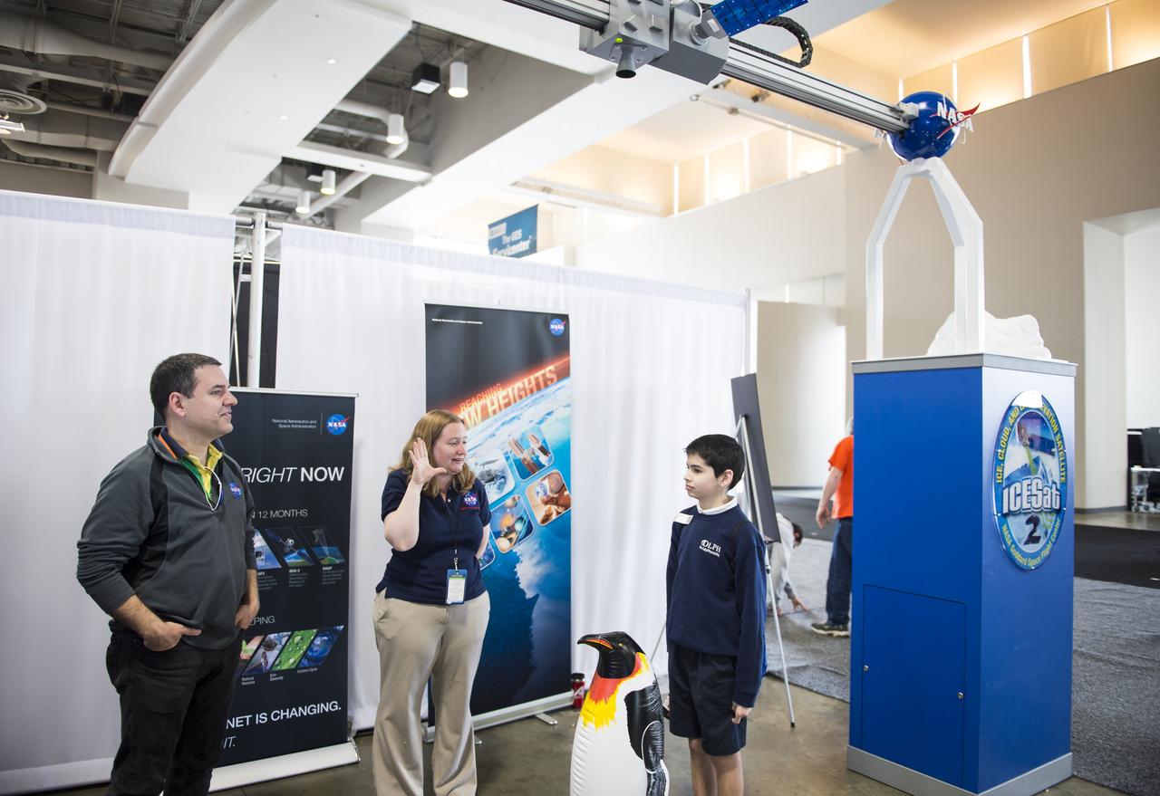 An attendee of the USA Science and Engineering Festival is measured by a laser at the NASA Stage. A NASA Staff member describes the Ice, Cloud, and land Elevation Satellite (ICESat) mission, which operated from 2003-2009, and pioneered the use of laser altimeters in space to study the elevation of the Earth's surface and its changes. ICESat-2 is a follow-on mission to continue the ICESat observations and is scheduled to launch in 2017. The USA Science and Engineering Festival took place at the Washington Convention Center in Washington, DC on April 26 and 27, 2014. Photo Credit: (NASA/Aubrey Gemignani)