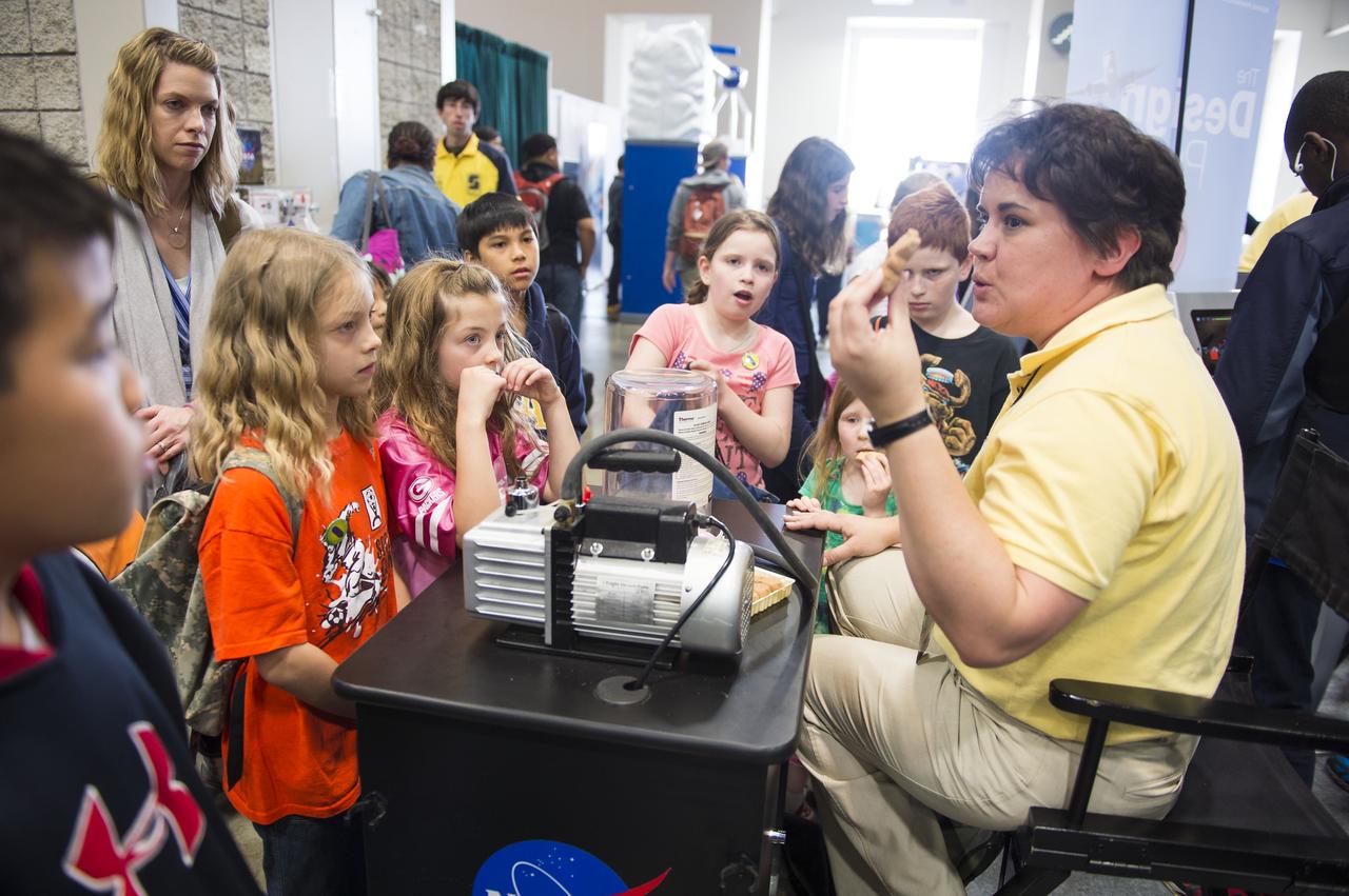 A NASA staff member shows attendees of the USA Science and Engineering Festival what happens to the human body in space without a space suit using a marshmallow bunny. The USA Science and Engineering Festival took place at the Washington Convention Center in Washington, DC on April 26 and 27, 2014. Photo Credit: (NASA/Aubrey Gemignani)