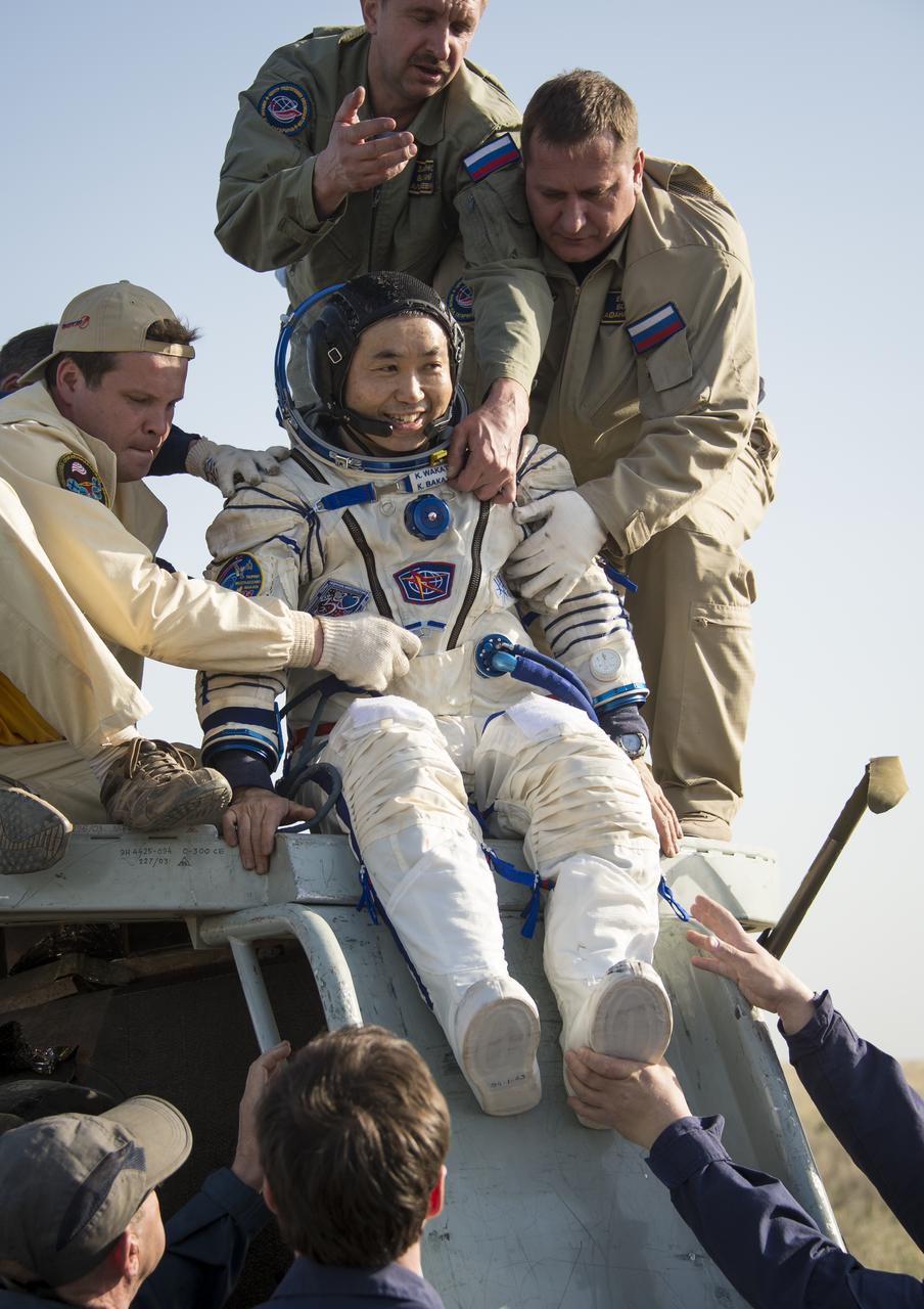 Expedition 39 Commander Koichi Wakata of the Japan Aerospace Exploration Agency (JAXA) is helped of the Soyuz Capsule just minutes after he and Soyuz Commander Mikhail Tyurin of Roscosmos, and Flight Engineer Rick Mastracchio of NASA, landed in their Soyuz TMA-11M spacecraft near the town of Zhezkazgan, Kazakhstan on Wednesday, May 14, 2014. Wakata, Tyurin and Mastracchio returned to Earth after more than six months onboard the International Space Station where they served as members of the Expedition 38 and 39 crews. Photo Credit: (NASA/Bill Ingalls)