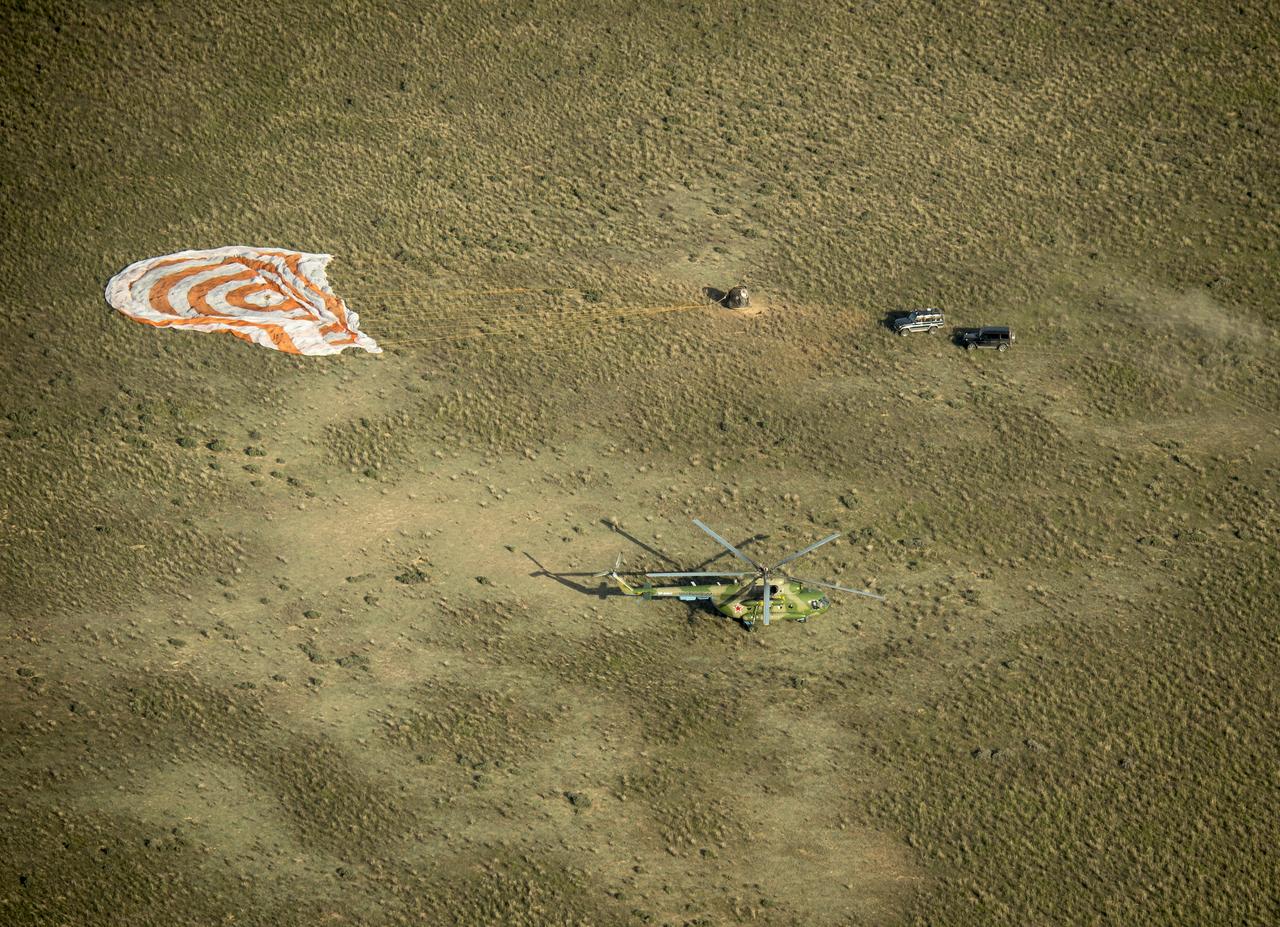Support personnel race to the landing site as the Soyuz TMA-11M spacecraft lands with Expedition 39 Commander Koichi Wakata of the Japan Aerospace Exploration Agency (JAXA), Soyuz Commander Mikhail Tyurin of Roscosmos, and Flight Engineer Rick Mastracchio of NASA near the town of Zhezkazgan, Kazakhstan on Wednesday, May 14, 2014. Wakata, Tyurin and Mastracchio returned to Earth after more than six months onboard the International Space Station where they served as members of the Expedition 38 and 39 crews. Photo Credit: (NASA/Bill Ingalls)