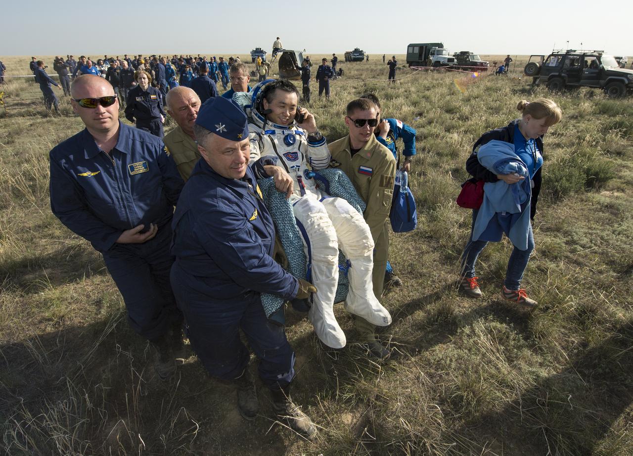 Expedition 39 Commander Koichi Wakata of the Japan Aerospace Exploration Agency (JAXA) is carried in a chair to a medical tent just minutes after he and Soyuz Commander Mikhail Tyurin of Roscosmos, and Flight Engineer Rick Mastracchio of NASA, landed in their Soyuz TMA-11M spacecraft near the town of Zhezkazgan, Kazakhstan on Wednesday, May 14, 2014. Wakata, Tyurin and Mastracchio returned to Earth after more than six months onboard the International Space Station where they served as members of the Expedition 38 and 39 crews. Photo Credit: (NASA/Bill Ingalls)