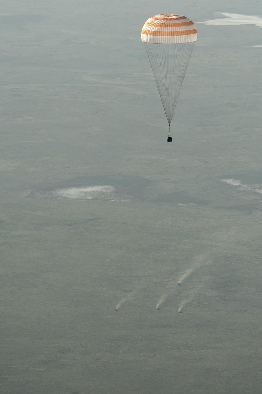 Ground personnel race to the landing site as the Soyuz TMA-11M spacecraft lands with Expedition 39 Commander Koichi Wakata of the Japan Aerospace Exploration Agency (JAXA), Soyuz Commander Mikhail Tyurin of Roscosmos, and Flight Engineer Rick Mastracchio of NASA near the town of Zhezkazgan, Kazakhstan on Wednesday, May 14, 2014. Wakata, Tyurin and Mastracchio returned to Earth after more than six months onboard the International Space Station where they served as members of the Expedition 38 and 39 crews. Photo Credit: (NASA/Bill Ingalls)