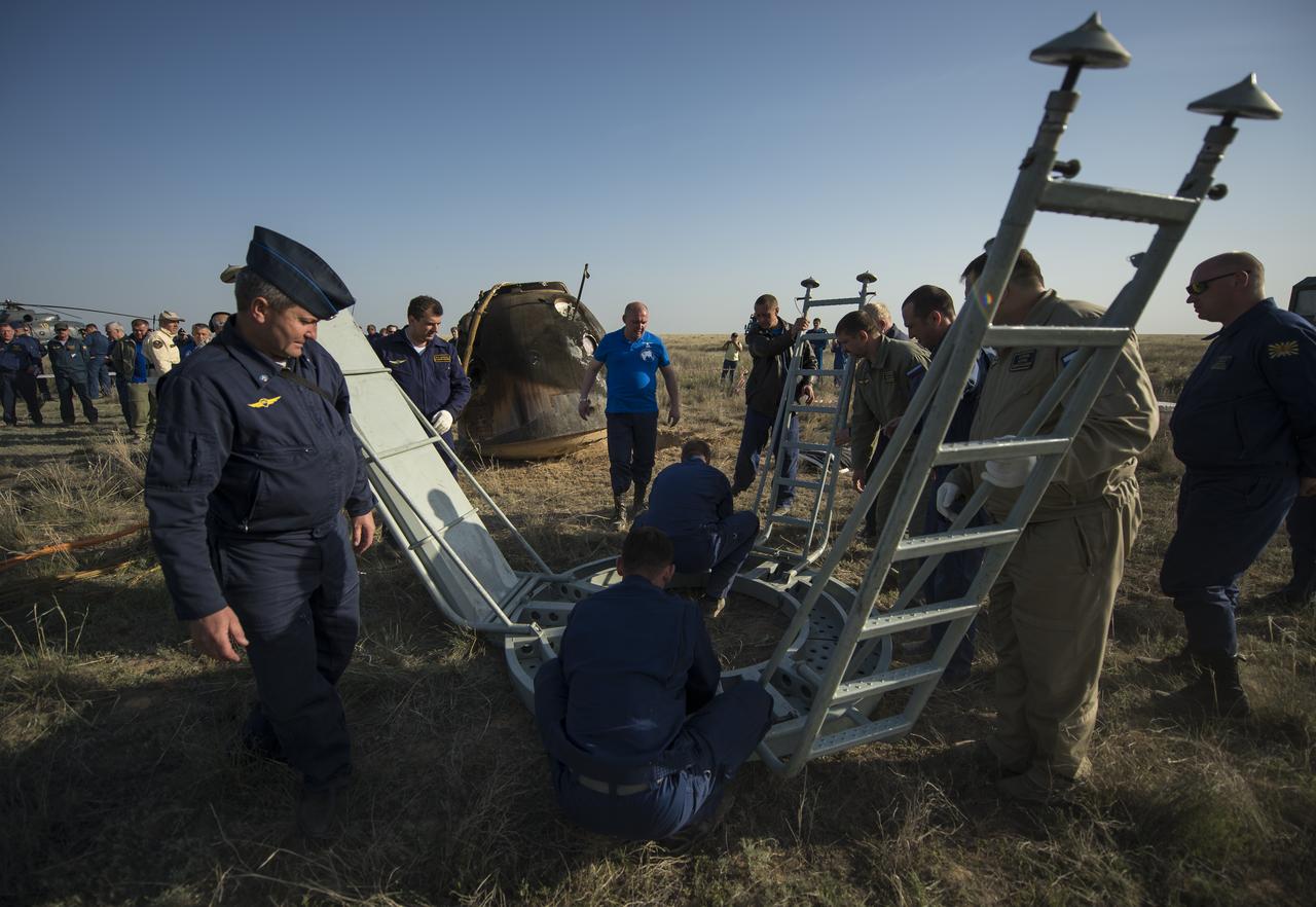 Support personnel prepare to exact the crew from the Soyuz TMA-11M spacecraft shortly after it landed with Expedition 39 Commander Koichi Wakata of the Japan Aerospace Exploration Agency (JAXA), Soyuz Commander Mikhail Tyurin of Roscosmos, and Flight Engineer Rick Mastracchio of NASA near the town of Zhezkazgan, Kazakhstan on Wednesday, May 14, 2014. Wakata, Tyurin and Mastracchio returned to Earth after more than six months onboard the International Space Station where they served as members of the Expedition 38 and 39 crews. Photo Credit: (NASA/Bill Ingalls)