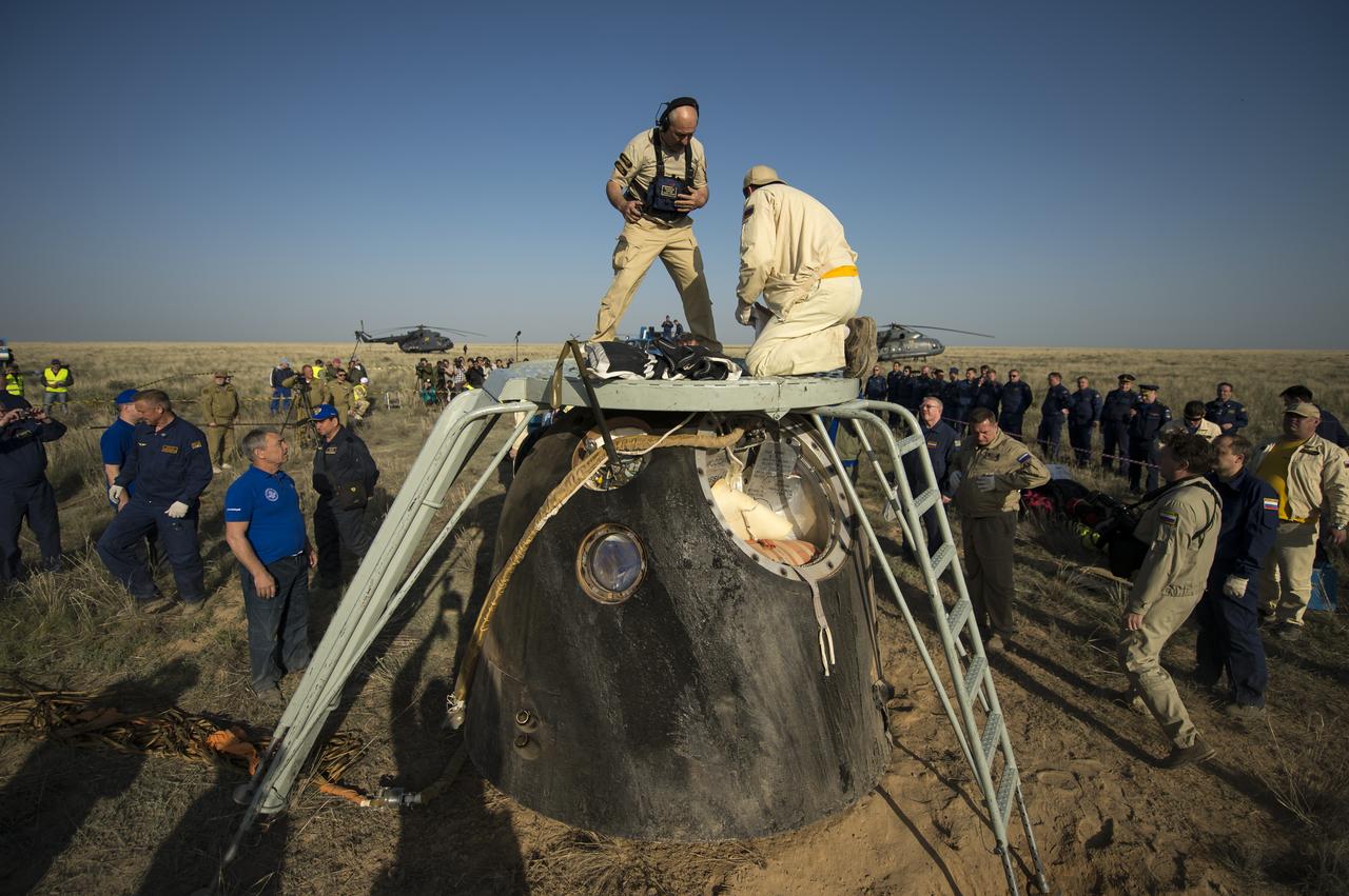 Support personnel prepare to exact the crew from the Soyuz TMA-11M spacecraft shortly after it landed with Expedition 39 Commander Koichi Wakata of the Japan Aerospace Exploration Agency (JAXA), Soyuz Commander Mikhail Tyurin of Roscosmos, and Flight Engineer Rick Mastracchio of NASA near the town of Zhezkazgan, Kazakhstan on Wednesday, May 14, 2014. Wakata, Tyurin and Mastracchio returned to Earth after more than six months onboard the International Space Station where they served as members of the Expedition 38 and 39 crews. Photo Credit: (NASA/Bill Ingalls)