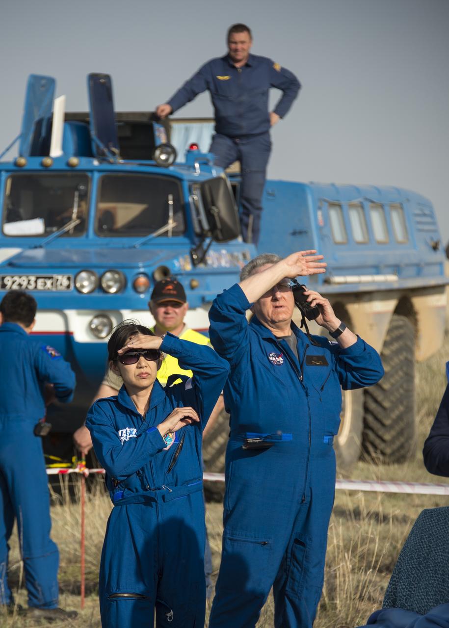 Support personnel wait for the Expedition 39 crew members to be extracted from the Soyuz TMA-11M spacecraft shortly after it landed with Expedition 39 Commander Koichi Wakata of the Japan Aerospace Exploration Agency (JAXA), Soyuz Commander Mikhail Tyurin of Roscosmos, and Flight Engineer Rick Mastracchio of NASA near the town of Zhezkazgan, Kazakhstan on Wednesday, May 14, 2014. Wakata, Tyurin and Mastracchio returned to Earth after more than six months onboard the International Space Station where they served as members of the Expedition 38 and 39 crews. Photo Credit: (NASA/Bill Ingalls)