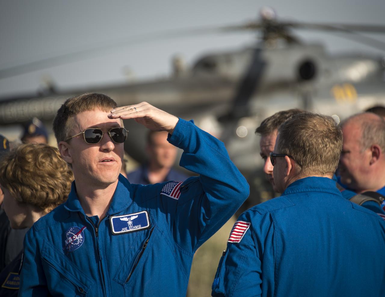 NASA Flight Surgeon Joseph Schmid waits for the Expedition 39 crew members to be extracted from the Soyuz TMA-11M spacecraft shortly after it landed with Expedition 39 Commander Koichi Wakata of the Japan Aerospace Exploration Agency (JAXA), Soyuz Commander Mikhail Tyurin of Roscosmos, and Flight Engineer Rick Mastracchio of NASA near the town of Zhezkazgan, Kazakhstan on Wednesday, May 14, 2014. Wakata, Tyurin and Mastracchio returned to Earth after more than six months onboard the International Space Station where they served as members of the Expedition 38 and 39 crews. Photo Credit: (NASA/Bill Ingalls)