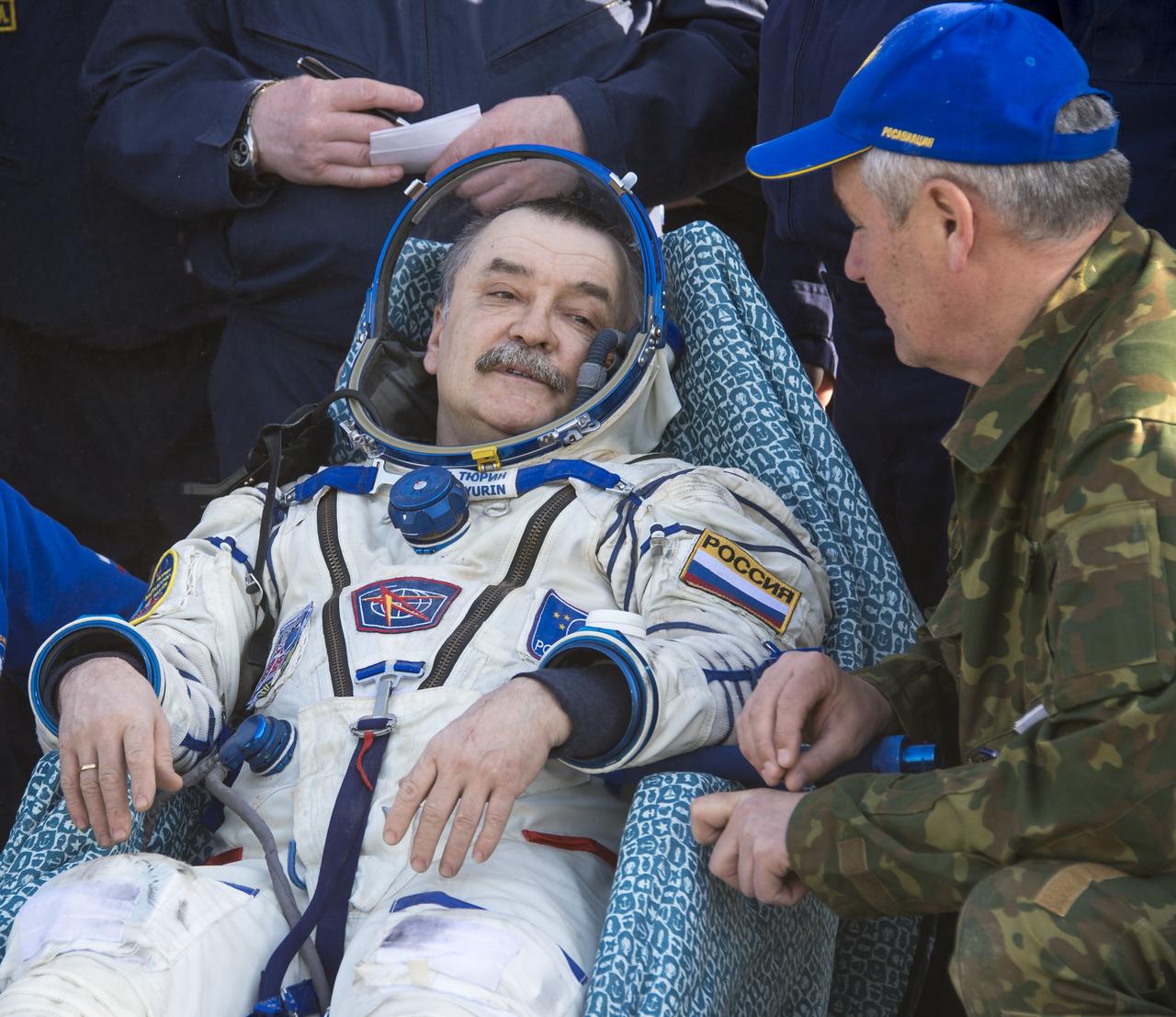 Soyuz Commander Mikhail Tyurin of Roscosmos rests in a chair outside the Soyuz Capsule just minutes after he and Expedition 39 Commander Koichi Wakata of the Japan Aerospace Exploration Agency (JAXA), and Flight Engineer Rick Mastracchio of NASA, landed in their Soyuz TMA-11M spacecraft near the town of Zhezkazgan, Kazakhstan on Wednesday, May 14, 2014. Wakata, Tyurin and Mastracchio returned to Earth after more than six months onboard the International Space Station where they served as members of the Expedition 38 and 39 crews. Photo Credit: (NASA/Bill Ingalls)