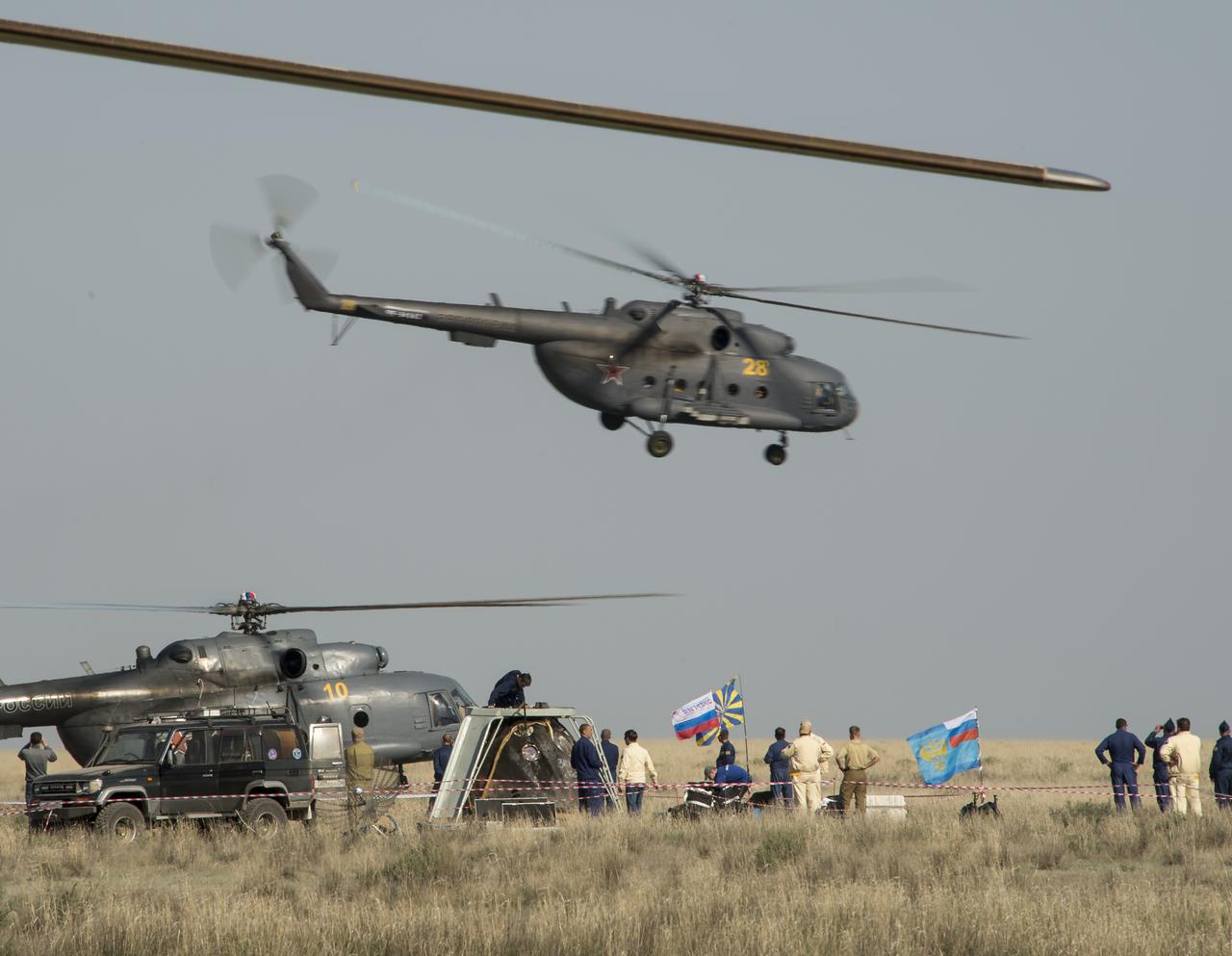 Support personnel are seen working around the Soyuz TMA-11M spacecraft after it landed with Expedition 39 Commander Koichi Wakata of the Japan Aerospace Exploration Agency (JAXA), Soyuz Commander Mikhail Tyurin of Roscosmos, and Flight Engineer Rick Mastracchio of NASA near the town of Zhezkazgan, Kazakhstan on Wednesday, May 14, 2014. Wakata, Tyurin and Mastracchio returned to Earth after more than six months onboard the International Space Station where they served as members of the Expedition 38 and 39 crews. Photo Credit: (NASA/Bill Ingalls)