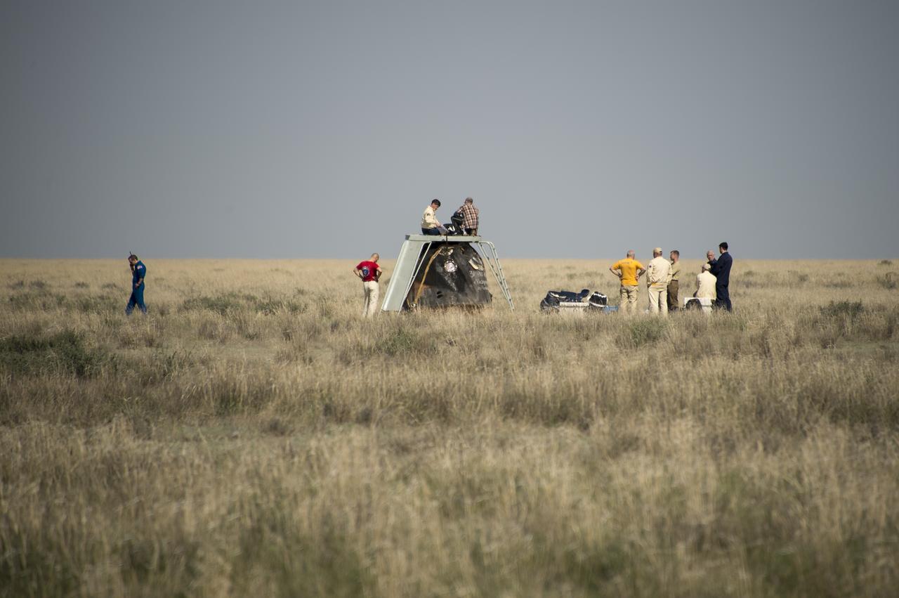 The last of the support personnel are seen working around the Soyuz TMA-11M spacecraft after it landed with Expedition 39 Commander Koichi Wakata of the Japan Aerospace Exploration Agency (JAXA), Soyuz Commander Mikhail Tyurin of Roscosmos, and Flight Engineer Rick Mastracchio of NASA near the town of Zhezkazgan, Kazakhstan on Wednesday, May 14, 2014. Wakata, Tyurin and Mastracchio returned to Earth after more than six months onboard the International Space Station where they served as members of the Expedition 38 and 39 crews. Photo Credit: (NASA/Bill Ingalls)
