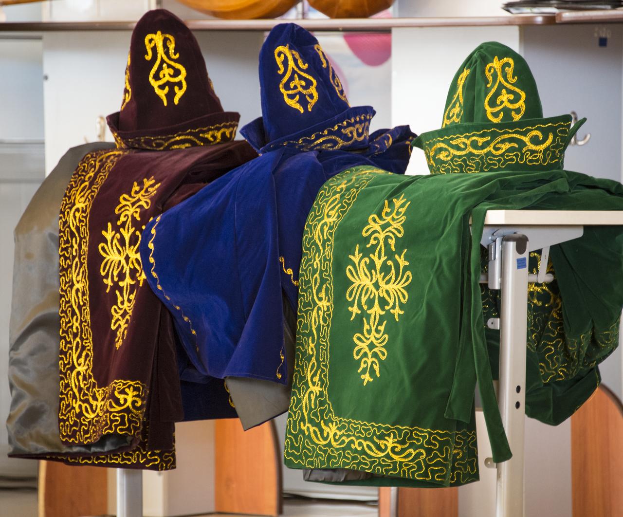 Ceremonial Kazakh hats and robes are laid out to be presented to Expedition 39 Commander Koichi Wakata of the Japan Aerospace Exploration Agency (JAXA), Soyuz Commander Mikhail Tyurin of Roscosmos, and Flight Engineer Rick Mastracchio of NASA at a welcome ceremony, Wednesday, May 14, 2014 at the Karaganda Airport in Kazakhstan. Wakata, Tyurin and Mastracchio returned to Earth after more than six months onboard the International Space Station where they served as members of the Expedition 38 and 39 crews. Photo Credit: (NASA/Bill Ingalls)