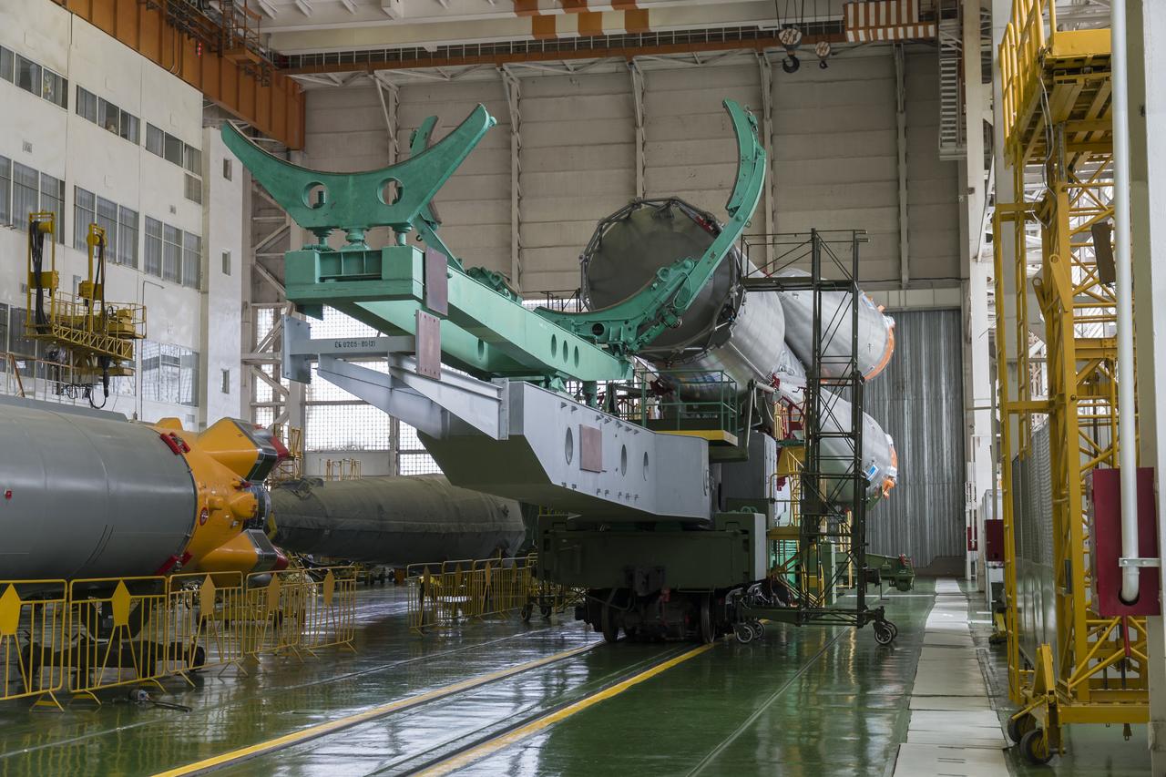 The Soyuz rocket and Soyuz TMA-13M spacecraft is assembled at Building 112 on the Baikonur Cosmodrome on Sunday, May 25, 2014 in Baikonur, Kazakhstan. Launch of the Soyuz is scheduled for May 29 and will send Expedition 40 Soyuz Commander Maxim Suraev of the Russian Federal Space Agency, Roscosmos, Flight Engineer Alexander Gerst of the European Space Agency, ESA, and Flight Engineer Reid Wiseman of NASA to the International Space Station for a five and a half month stay. Photo Credit: (NASA/Victor Zelentsov)