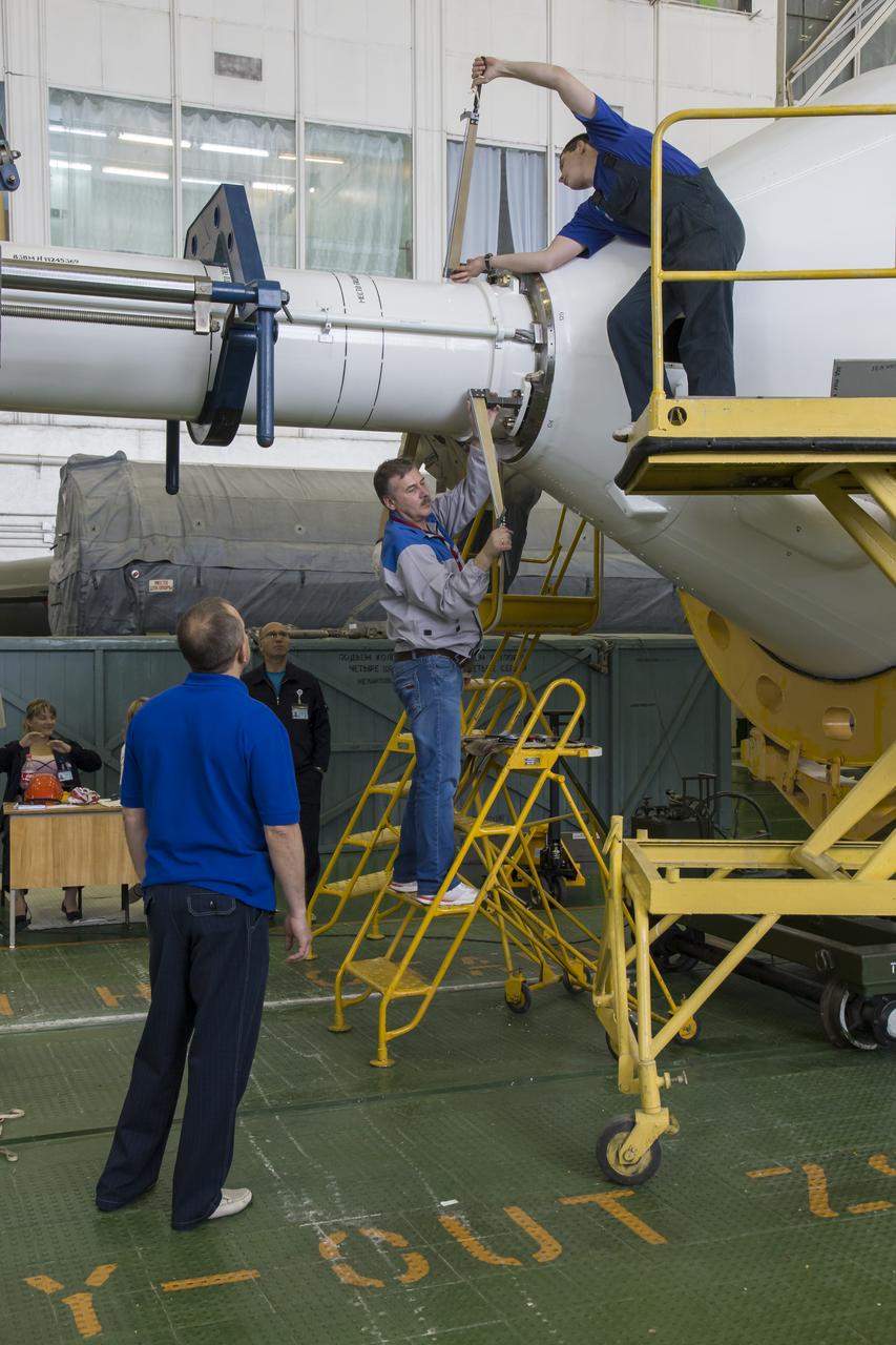 The Soyuz rocket and Soyuz TMA-13M spacecraft is assembled at Building 112 on the Baikonur Cosmodrome on Sunday, May 25, 2014 in Baikonur, Kazakhstan. Launch of the Soyuz is scheduled for May 29 and will send Expedition 40 Soyuz Commander Maxim Suraev of the Russian Federal Space Agency, Roscosmos, Flight Engineer Alexander Gerst of the European Space Agency, ESA, and Flight Engineer Reid Wiseman of NASA to the International Space Station for a five and a half month stay. Photo Credit: (NASA/Victor Zelentsov)