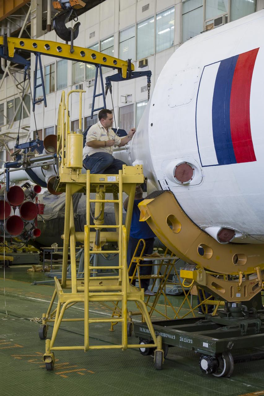 The Soyuz rocket and Soyuz TMA-13M spacecraft is assembled at Building 112 on the Baikonur Cosmodrome on Sunday, May 25, 2014 in Baikonur, Kazakhstan. Launch of the Soyuz is scheduled for May 29 and will send Expedition 40 Soyuz Commander Maxim Suraev of the Russian Federal Space Agency, Roscosmos, Flight Engineer Alexander Gerst of the European Space Agency, ESA, and Flight Engineer Reid Wiseman of NASA to the International Space Station for a five and a half month stay.  Photo Credit: (NASA/Victor Zelentsov)