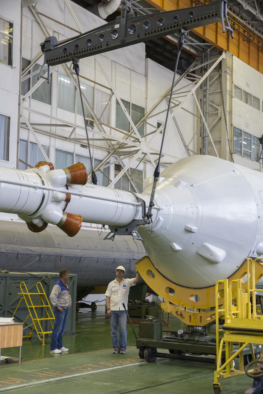 The Soyuz rocket and Soyuz TMA-13M spacecraft is assembled at Building 112 on the Baikonur Cosmodrome on Sunday, May 25, 2014 in Baikonur, Kazakhstan. Launch of the Soyuz is scheduled for May 29 and will send Expedition 40 Soyuz Commander Maxim Suraev of the Russian Federal Space Agency, Roscosmos, Flight Engineer Alexander Gerst of the European Space Agency, ESA, and Flight Engineer Reid Wiseman of NASA to the International Space Station for a five and a half month stay.  Photo Credit: (NASA/Victor Zelentsov)