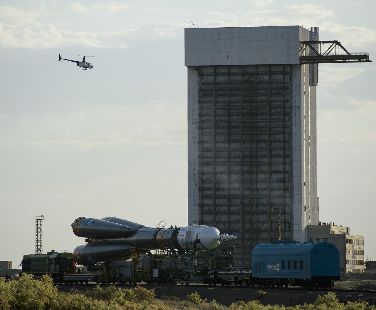 The Soyuz TMA-13M spacecraft is rolled out to the launch pad by train on Monday, May 26, 2014, at the Baikonur Cosmodrome in Kazakhstan.  Launch of the Soyuz rocket is scheduled for May 29 and will send Expedition 40 Soyuz Commander Maxim Suraev, of the Russian Federal Space Agency, Roscosmos, Flight Engineer Alexander Gerst, of the European Space Agency, ESA, and Flight Engineer Reid Wiseman of NASA on a five and a half month mission aboard the International Space Station.  Photo Credit: (NASA/Joel Kowsky)