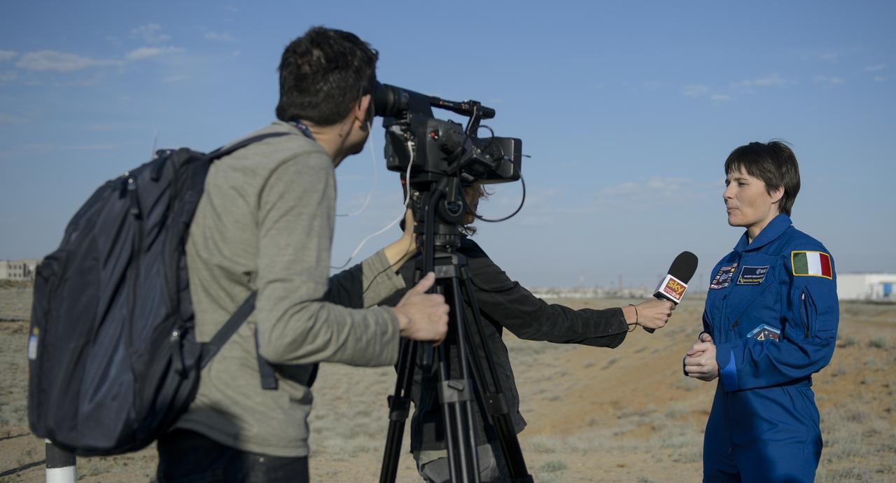Expedition 40 backup Flight Engineer Samantha Cristoforetti of the European Space Agency, ESA, is interviewed by members of the media during rollout activities on Monday, May 26, 2014, at the Baikonur Cosmodrome in Kazakhstan.  Cristoforetti is slated to launch to the International Space Station in November of 2014 as a member of Expedition 41.   Photo Credit: (NASA/Joel Kowsky)