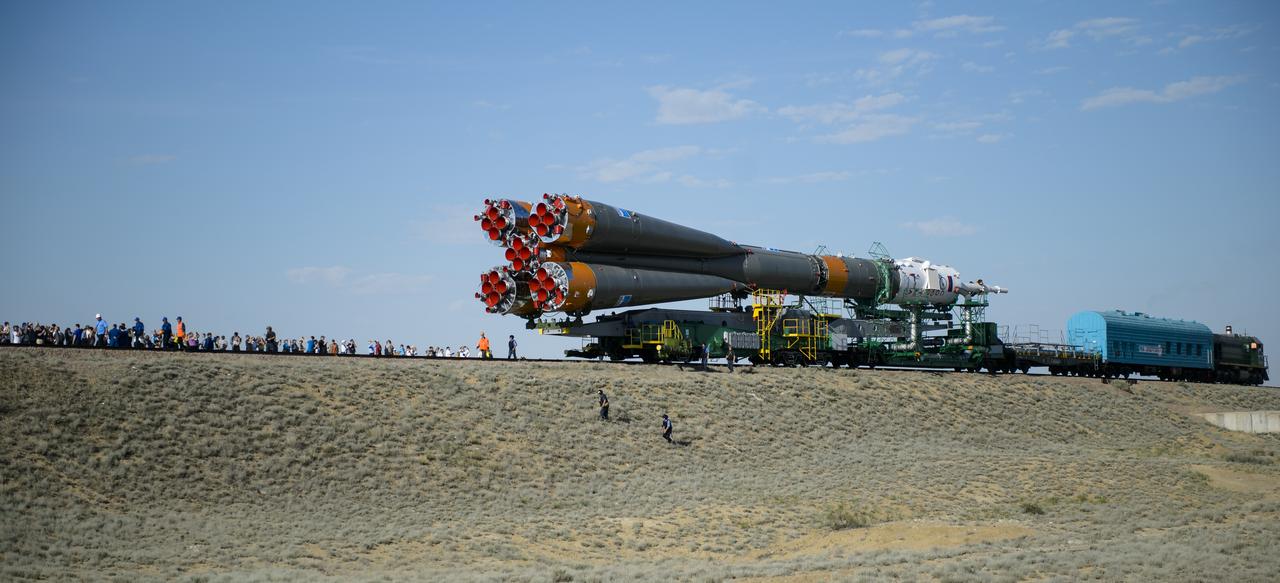 Guests and members of the media watch as the Soyuz TMA-13M spacecraft is rolled out to the launch pad by train on Monday, May 26, 2014, at the Baikonur Cosmodrome in Kazakhstan. Launch of the Soyuz rocket is scheduled for May 29 and will send Expedition 40 Soyuz Commander Maxim Suraev, of the Russian Federal Space Agency, Roscosmos, Flight Engineer Alexander Gerst, of the European Space Agency, ESA, and Flight Engineer Reid Wiseman of NASA on a five and a half month mission aboard the International Space Station. Photo Credit: (NASA/Joel Kowsky)