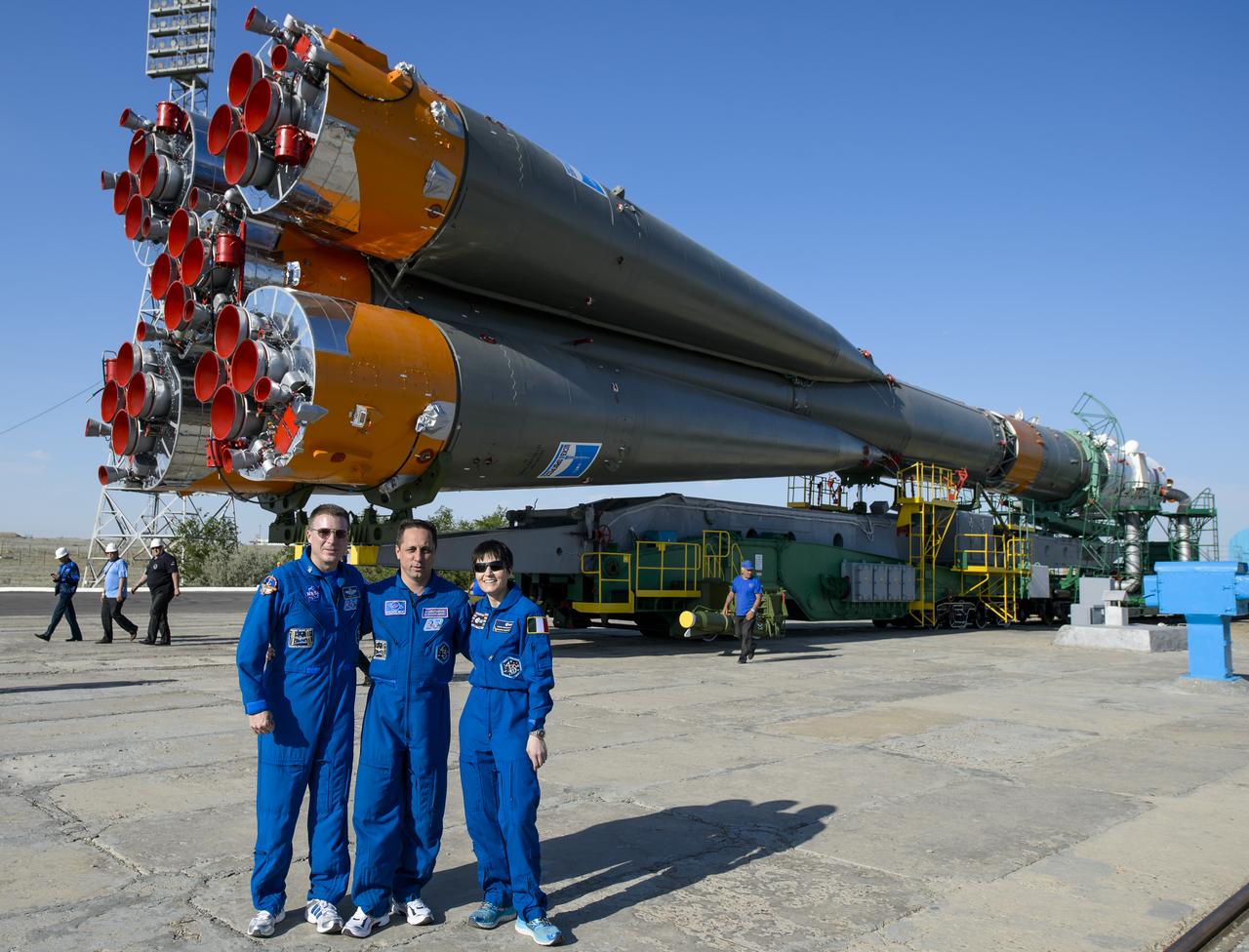 The Expedition 40 backup crew, Terry Virts of NASA, left, Soyuz Commander Anton Shkaplerov of the Russian Federal Space Agency, Roscosmos, center, and Flight Engineer Samantha Cristoforetti of the European Space Agency, ESA, right, are photographed in front of the Soyuz TMA-13M spacecraft as it arrives at the launch pad by train on Monday, May 26, 2014, at the Baikonur Cosmodrome in Kazakhstan. Launch of the Soyuz rocket is scheduled for May 29 and will send Expedition 40 Soyuz Commander Maxim Suraev, of the Russian Federal Space Agency, Roscosmos, Flight Engineer Alexander Gerst, of the European Space Agency, ESA, and Flight Engineer Reid Wiseman of NASA on a five and a half month mission aboard the International Space Station. Photo Credit: (NASA/Joel Kowsky)