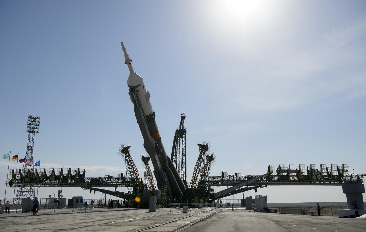 The Soyuz TMA-13M spacecraft is raised into a vertical position on the launch pad on Monday, May 26, 2014, at the Baikonur Cosmodrome in Kazakhstan.  Launch of the Soyuz rocket is scheduled for May 29 and will send Expedition 40 Soyuz Commander Maxim Suraev, of the Russian Federal Space Agency, Roscosmos, Flight Engineer Alexander Gerst, of the European Space Agency, ESA, and Flight Engineer Reid Wiseman of NASA on a five and a half month mission aboard the International Space Station.  Photo Credit: (NASA/Joel Kowsky)