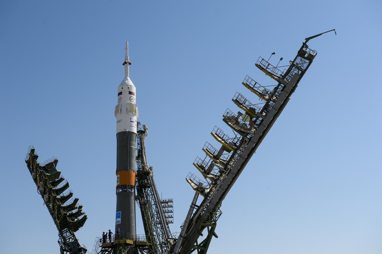 The Soyuz TMA-13M rocket is seen as the service structure arms are raised into position at the launch pad on Monday, May 26, 2014, at the Baikonur Cosmodrome in Kazakhstan.  Launch of the Soyuz rocket is scheduled for May 29 and will send Expedition 40 Soyuz Commander Maxim Suraev, of the Russian Federal Space Agency, Roscosmos, Flight Engineer Alexander Gerst, of the European Space Agency, ESA, and Flight Engineer Reid Wiseman of NASA on a five and a half month mission aboard the International Space Station.  Photo Credit: (NASA/Joel Kowsky)