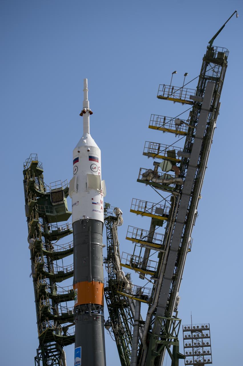 The Soyuz TMA-13M rocket is seen as the service structure arms are raised into position at the launch pad on Monday, May 26, 2014, at the Baikonur Cosmodrome in Kazakhstan.  Launch of the Soyuz rocket is scheduled for May 29 and will send Expedition 40 Soyuz Commander Maxim Suraev, of the Russian Federal Space Agency, Roscosmos, Flight Engineer Alexander Gerst, of the European Space Agency, ESA, and Flight Engineer Reid Wiseman of NASA on a five and a half month mission aboard the International Space Station.  Photo Credit: (NASA/Joel Kowsky)