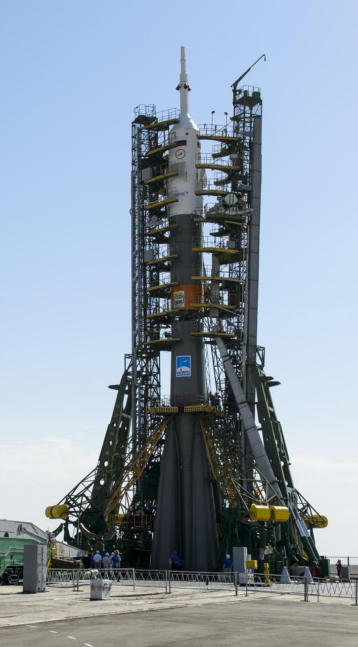 The Soyuz TMA-13M rocket is seen as the service structure arms are raised into position at the launch pad on Monday, May 26, 2014, at the Baikonur Cosmodrome in Kazakhstan.  Launch of the Soyuz rocket is scheduled for May 29 and will send Expedition 40 Soyuz Commander Maxim Suraev, of the Russian Federal Space Agency, Roscosmos, Flight Engineer Alexander Gerst, of the European Space Agency, ESA, and Flight Engineer Reid Wiseman of NASA on a five and a half month mission aboard the International Space Station.  Photo Credit: (NASA/Joel Kowsky)